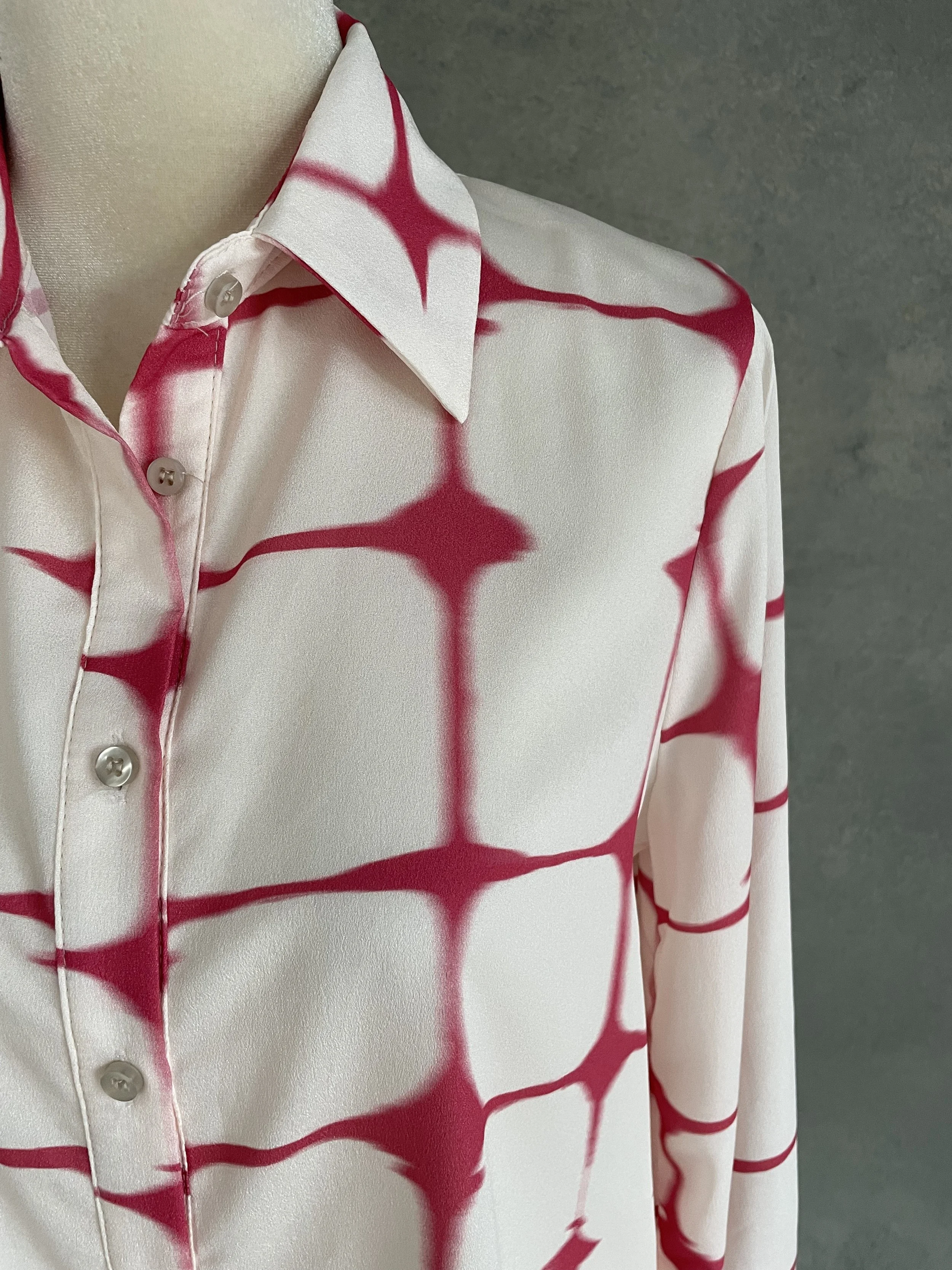 Close-up of the collar and button detailing, showcasing the coral pattern.
