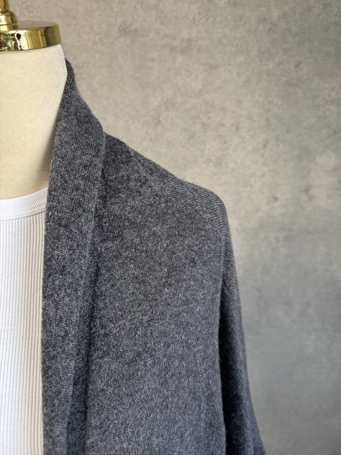 Close-up of fine cashmere knit texture and raglan shoulder seam