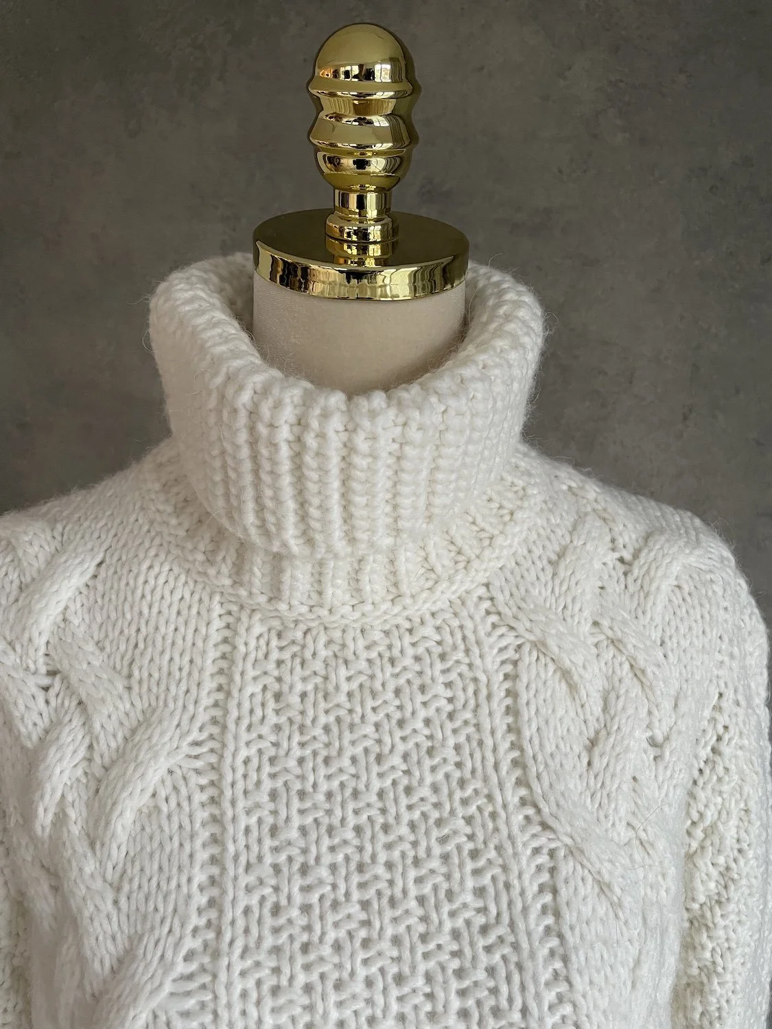 Close-up of the ribbed turtleneck and basketweave chest texture.