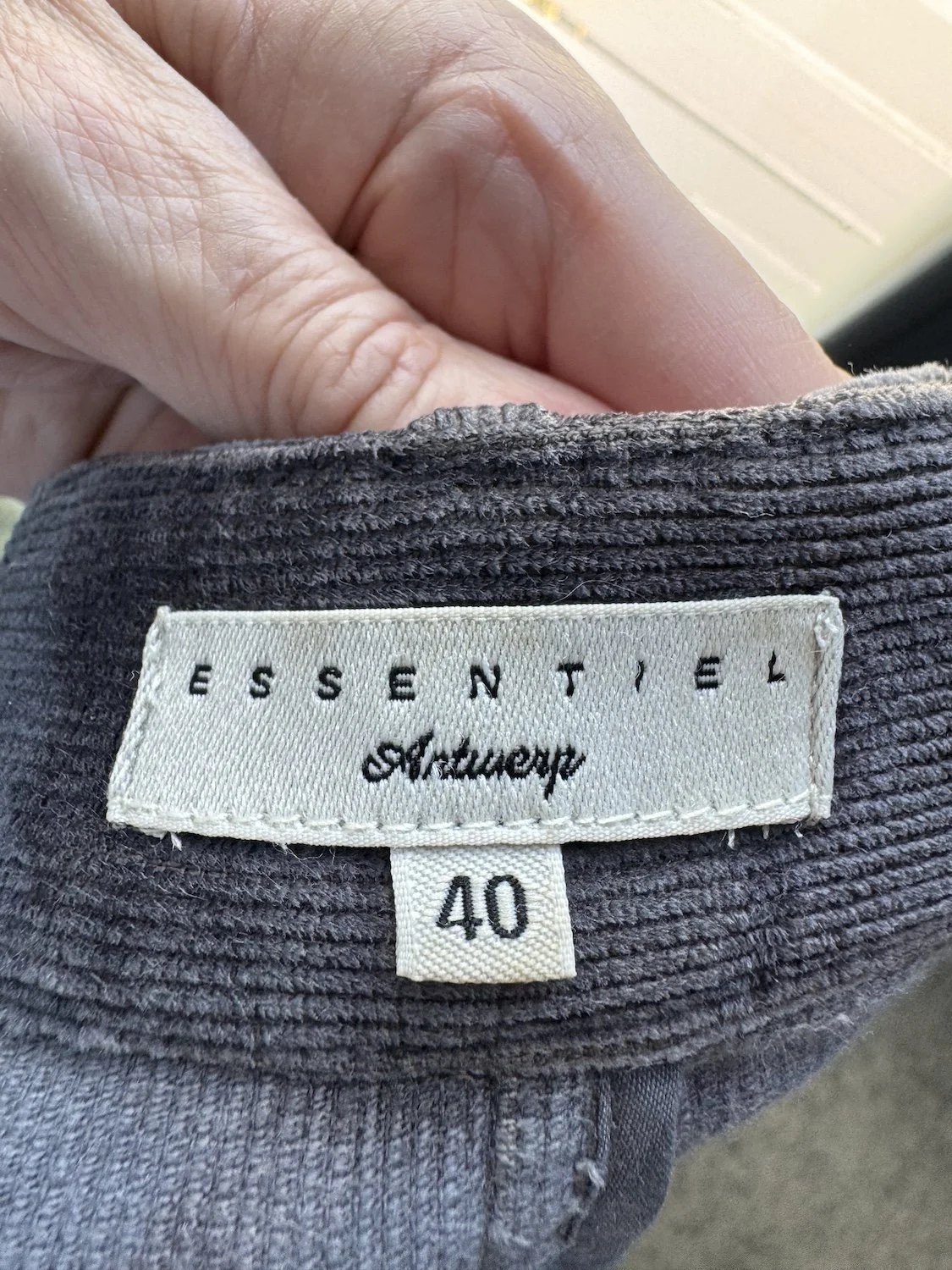 Close-up of the interior white "ESSENTIEL Antwerp" brand label and the size "40" tag.