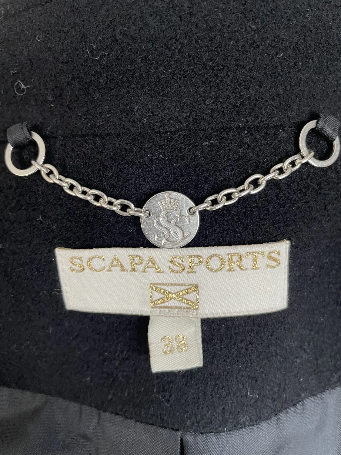 Scapa sports interior brand label showing size 38 and chain hanger