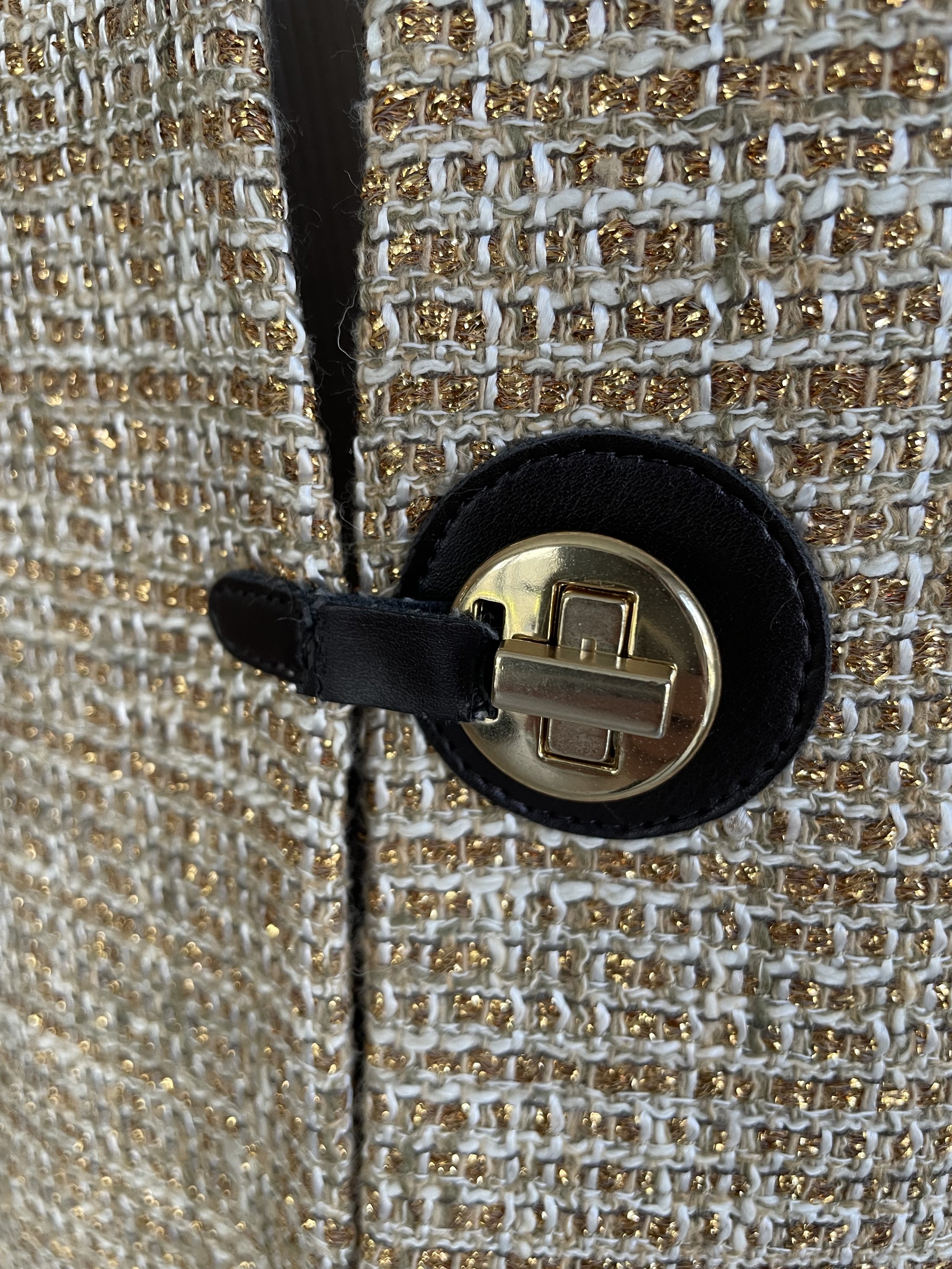 Close-up view of the Scapa coat collar and black toggle closure detail.