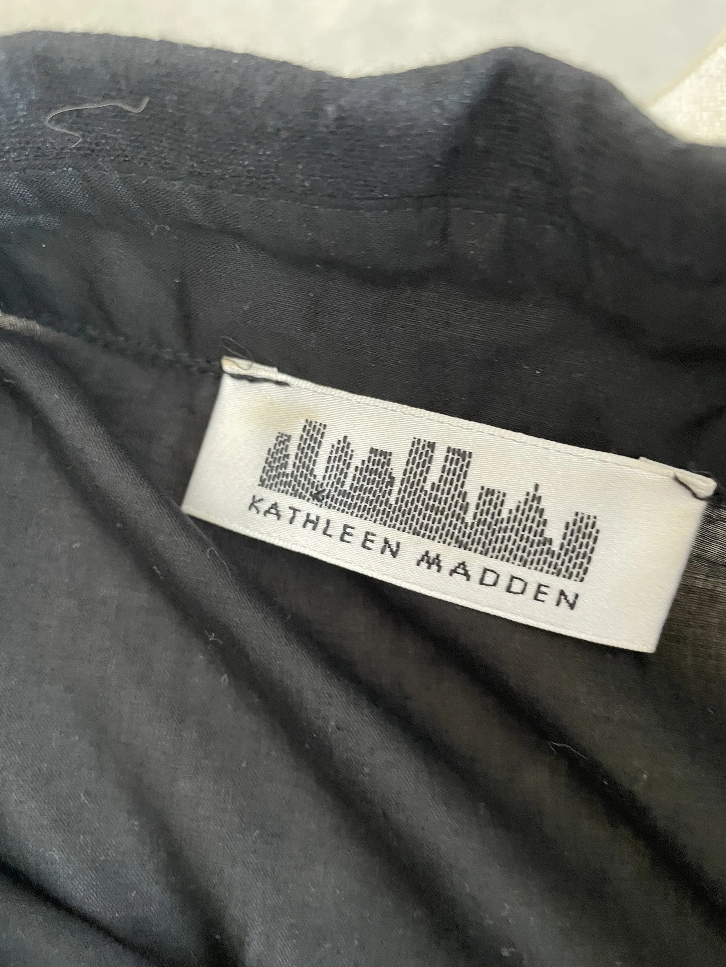 Detail view of the Kathleen Madden brand label and interior lining, confirming authenticity.