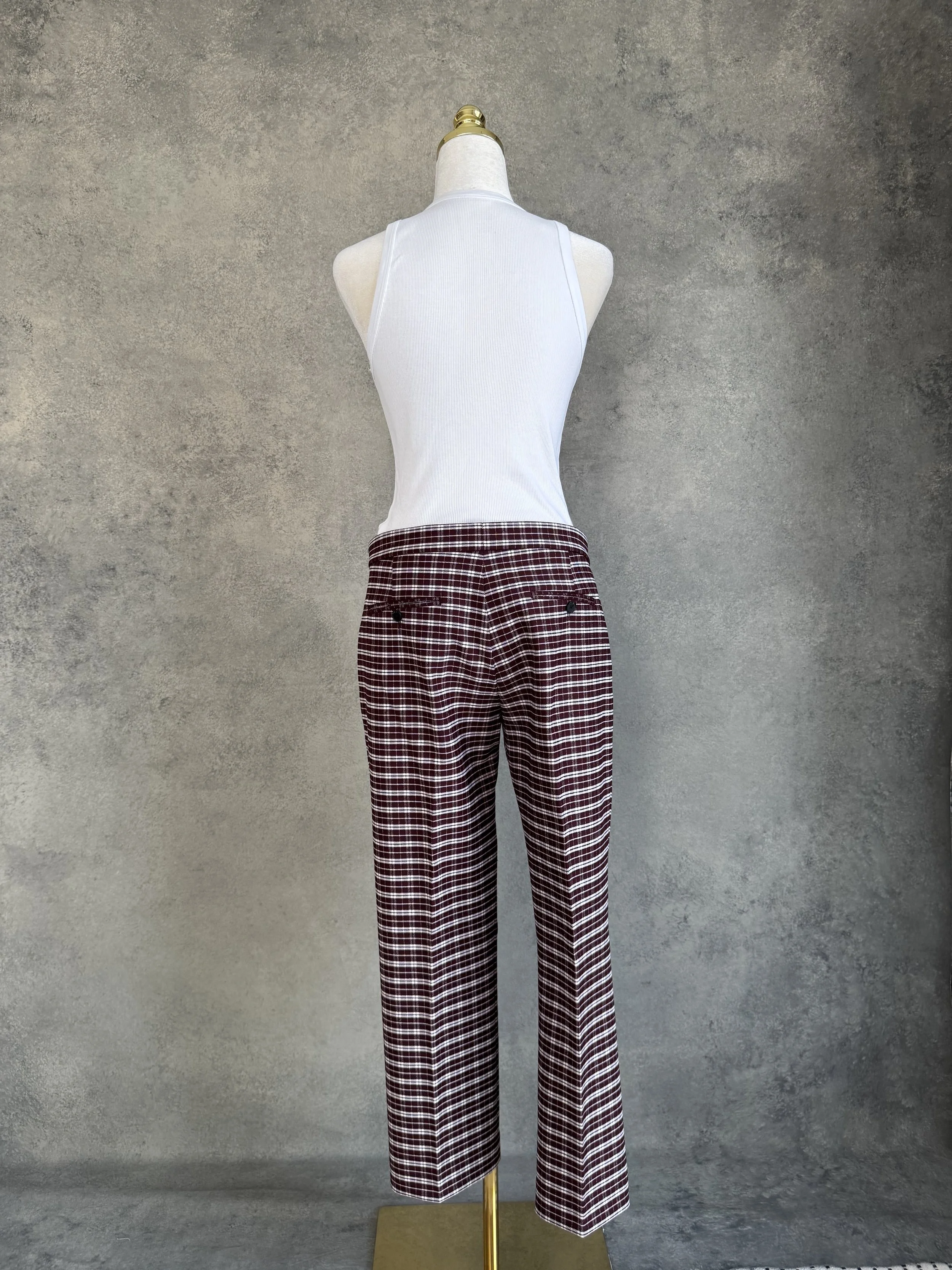 Full back view of the JOSEPH trousers on a mannequin, displaying the tailored rear welt pockets with button closures.