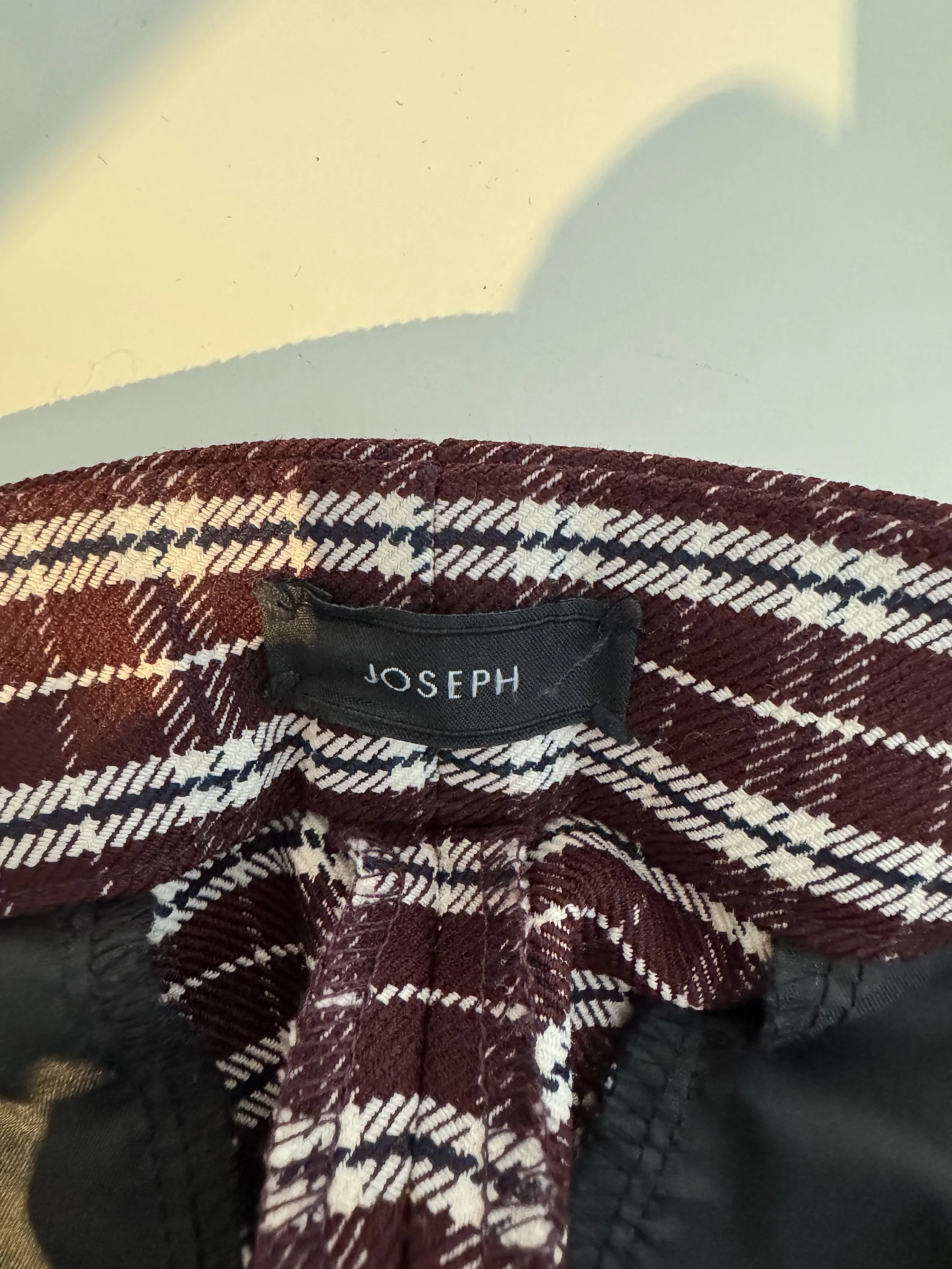 Close-up of the interior 'JOSEPH' designer brand label stitched inside the waistband.