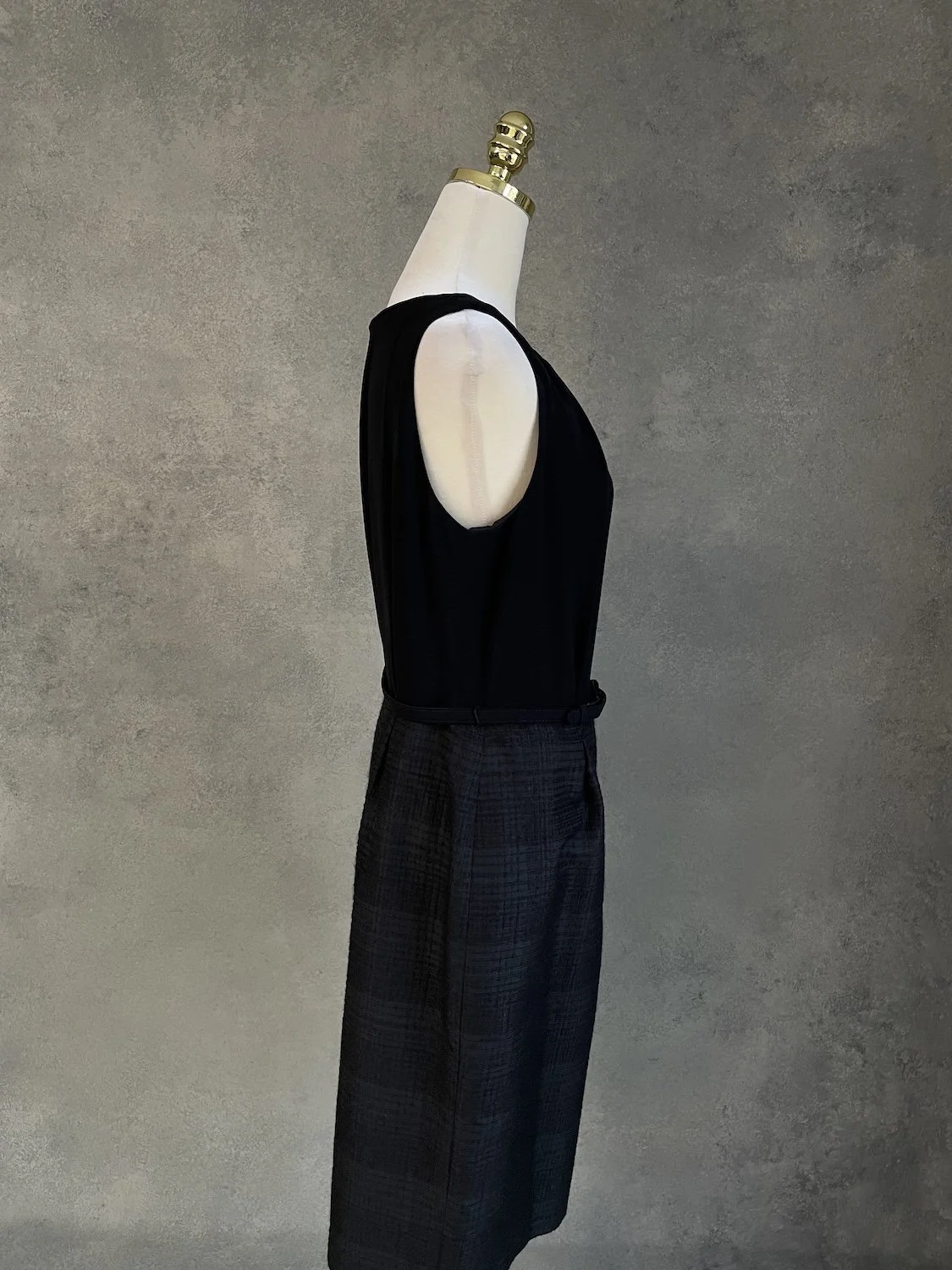 Side profile of the dress on the mannequin, illustrating the clean lines and fit.