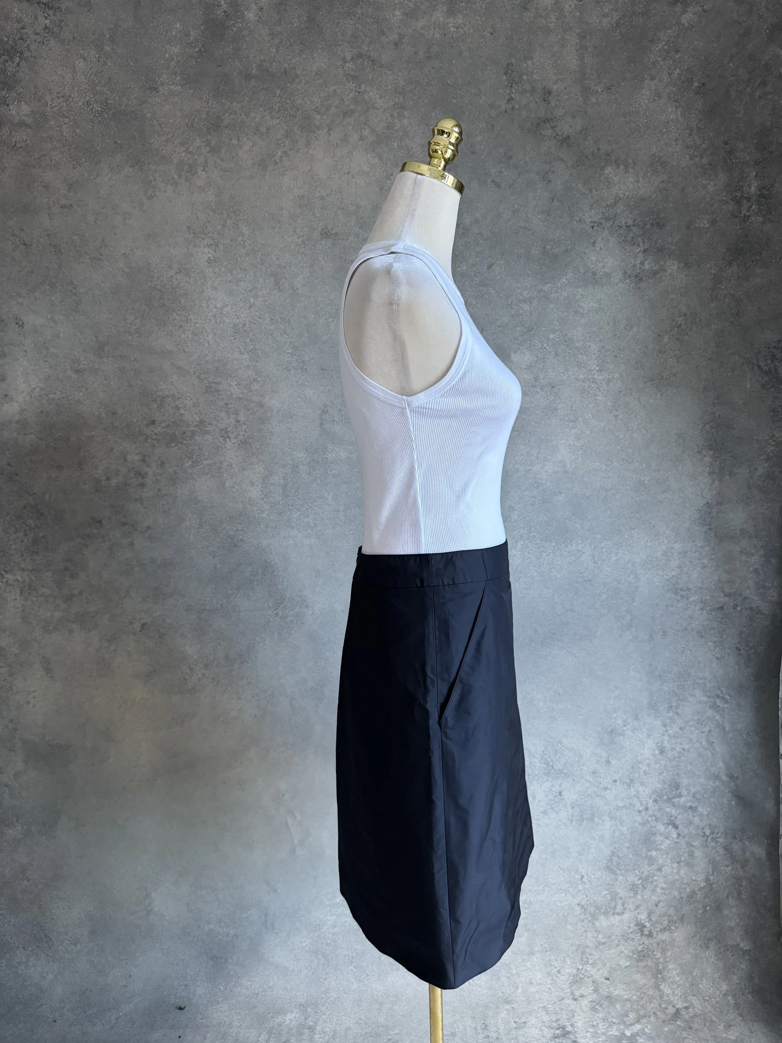 Side profile view of the black HUGO skirt on a mannequin, showing the clean cut and pocket detail.