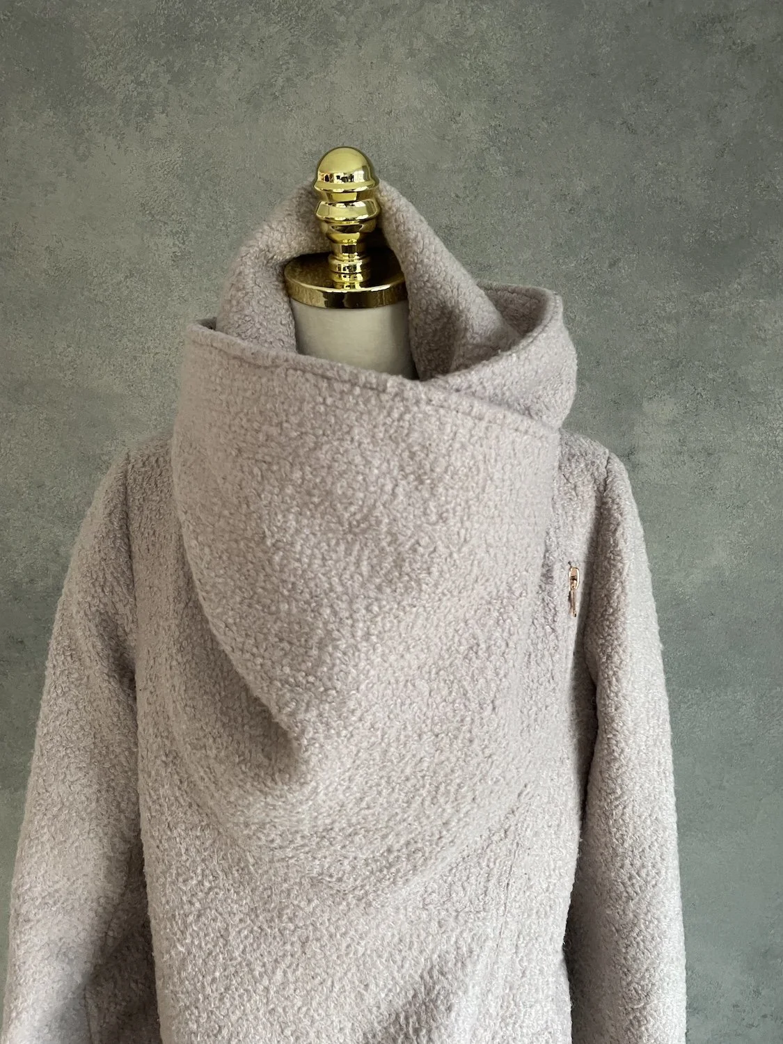 Close-up of the voluminous sculptural high-neck collar.
