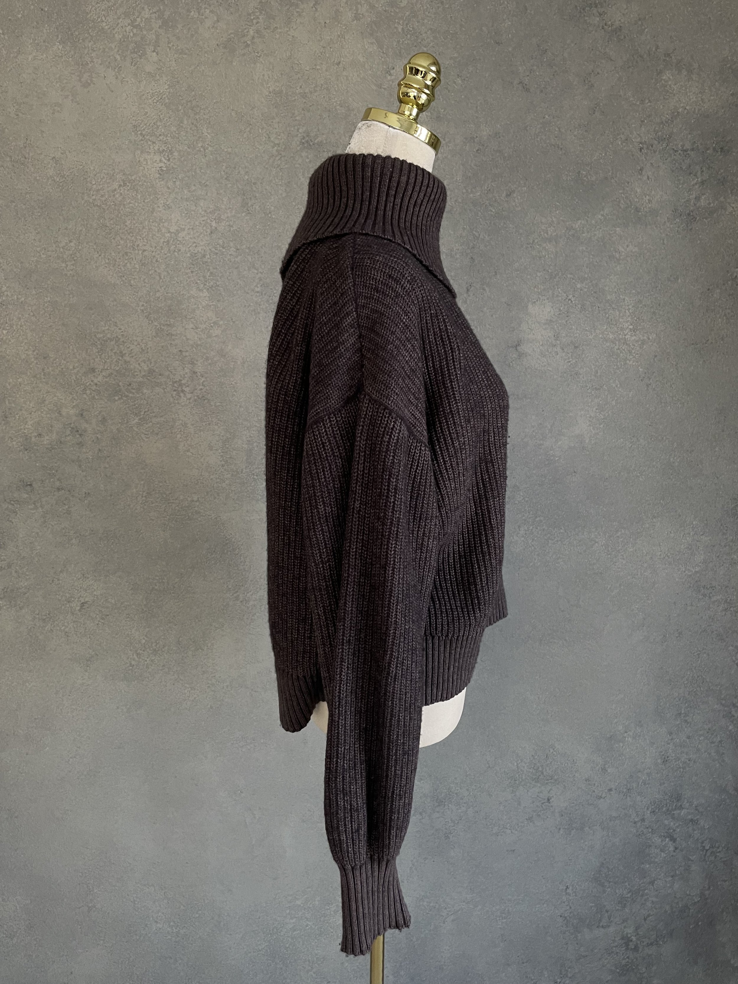 Side profile of the Blanche sweater, showcasing the ribbed knit texture and the contrast between the brown body and grey sleeve.