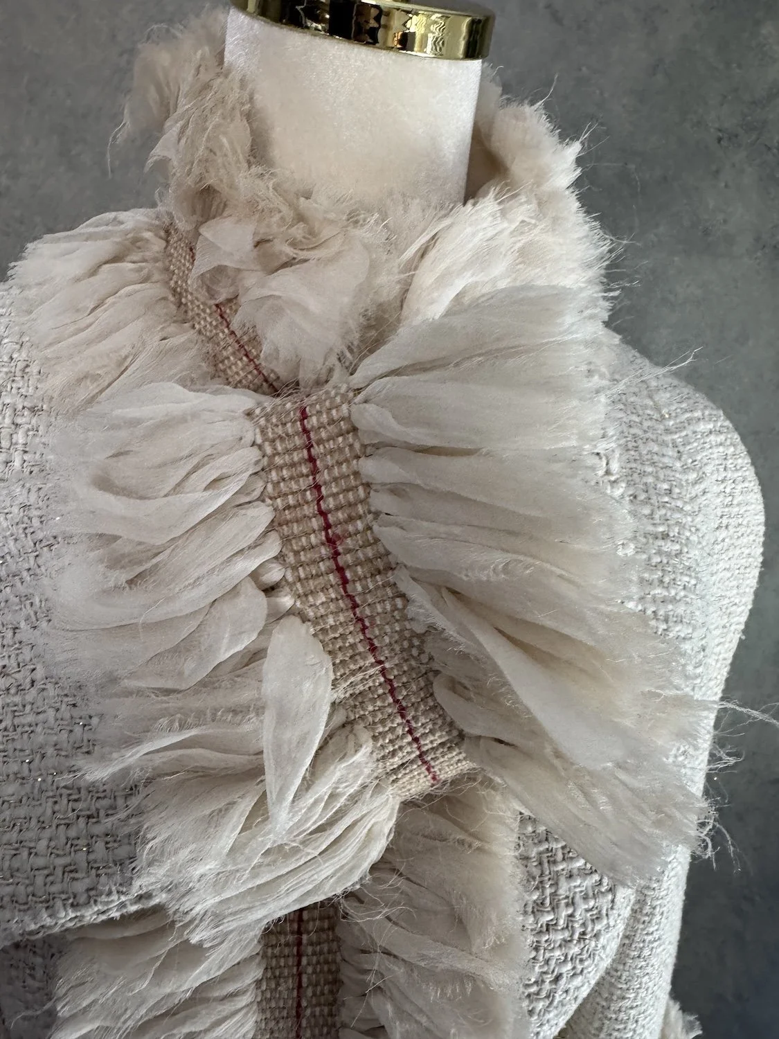 Detailed view of chiffon and fringe collar trim on Jantaminiau jacket