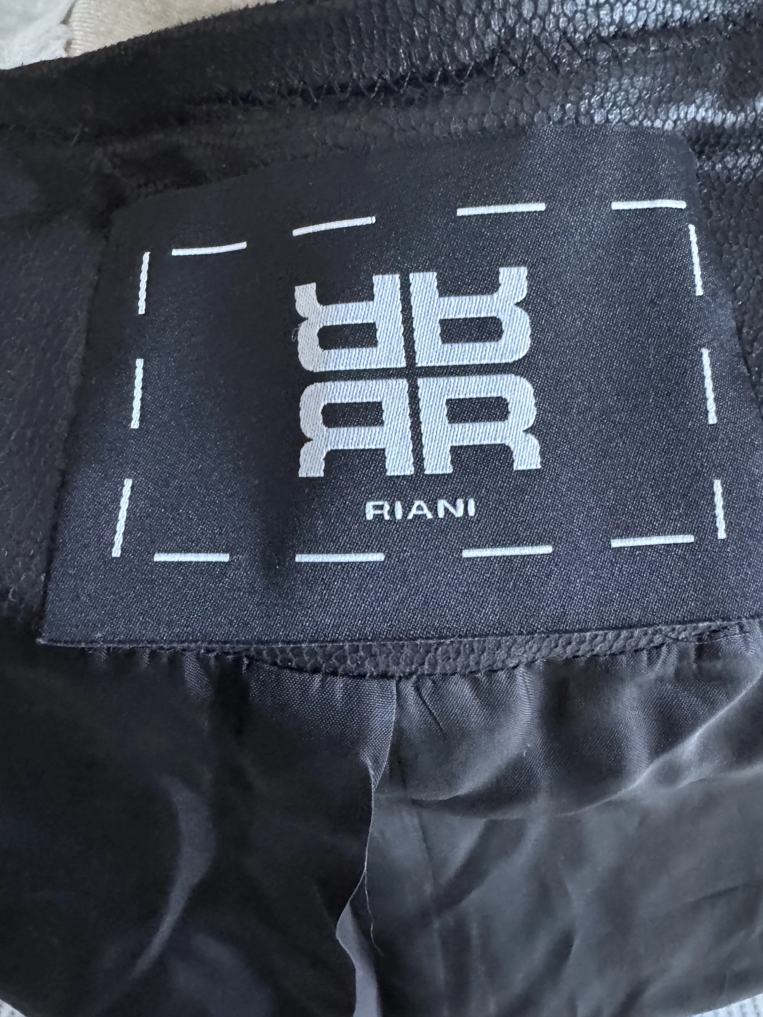 Close-up view of the side construction and leather-look panels on the Riani blazer.