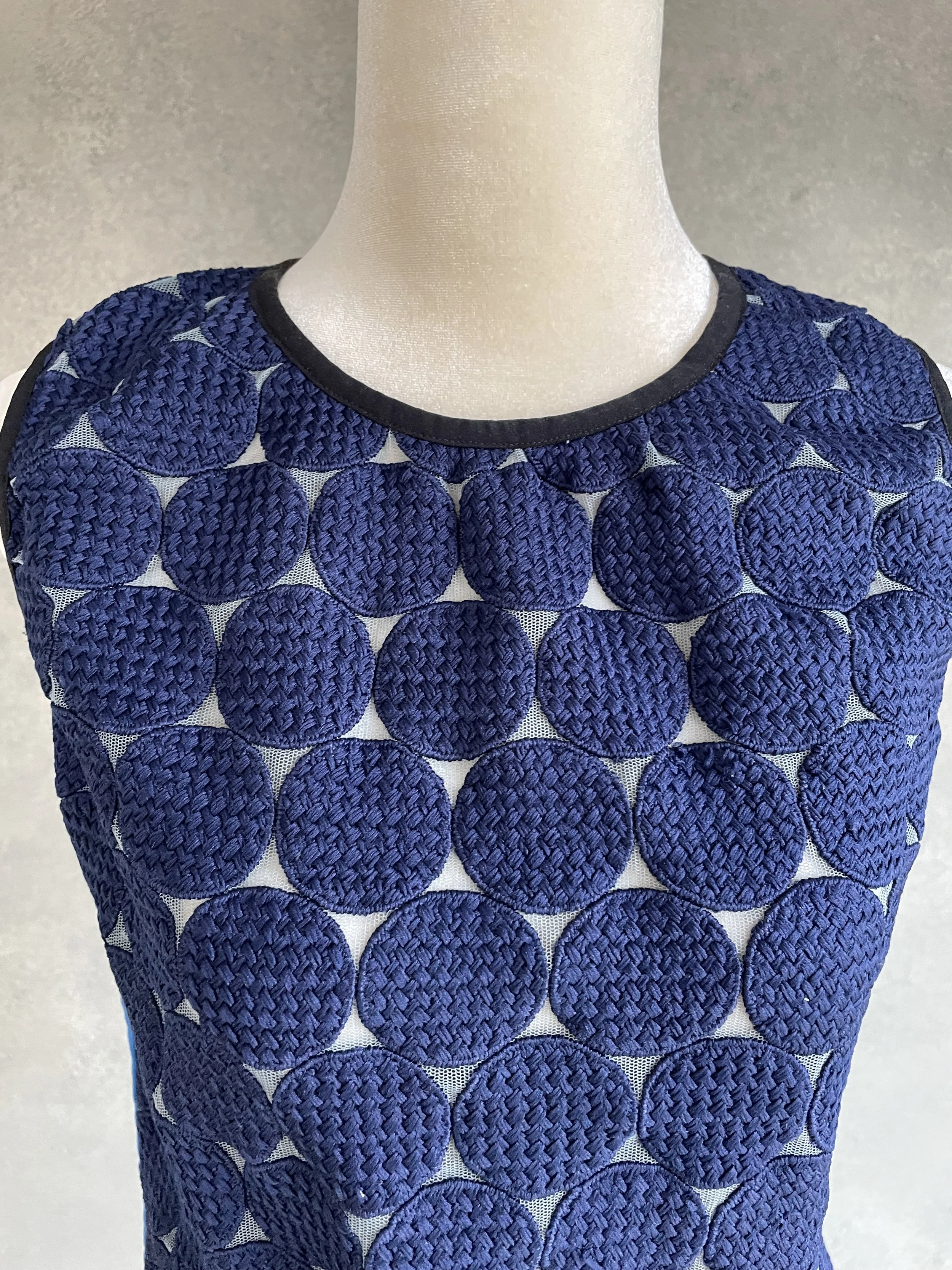 Detailed close-up of the circular knit texture on the front of the blue Vladimir Karaleev top.