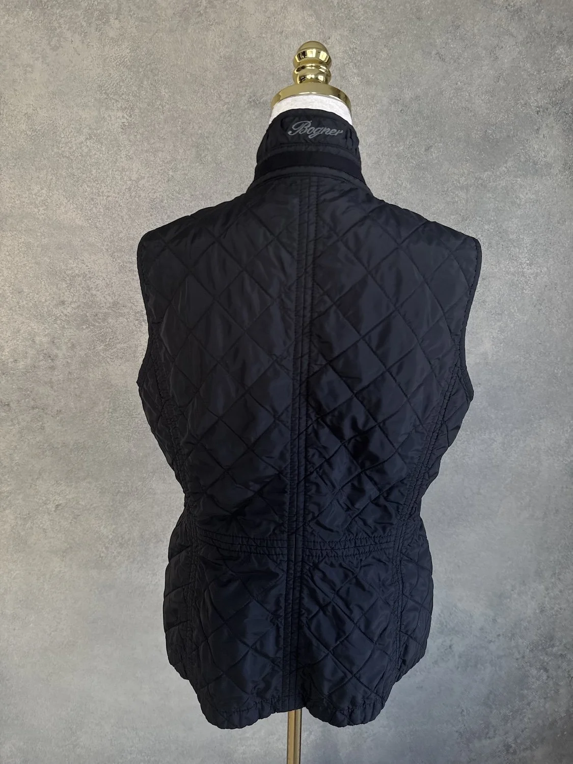 Bogner black quilted vest back view with tailored waist seam