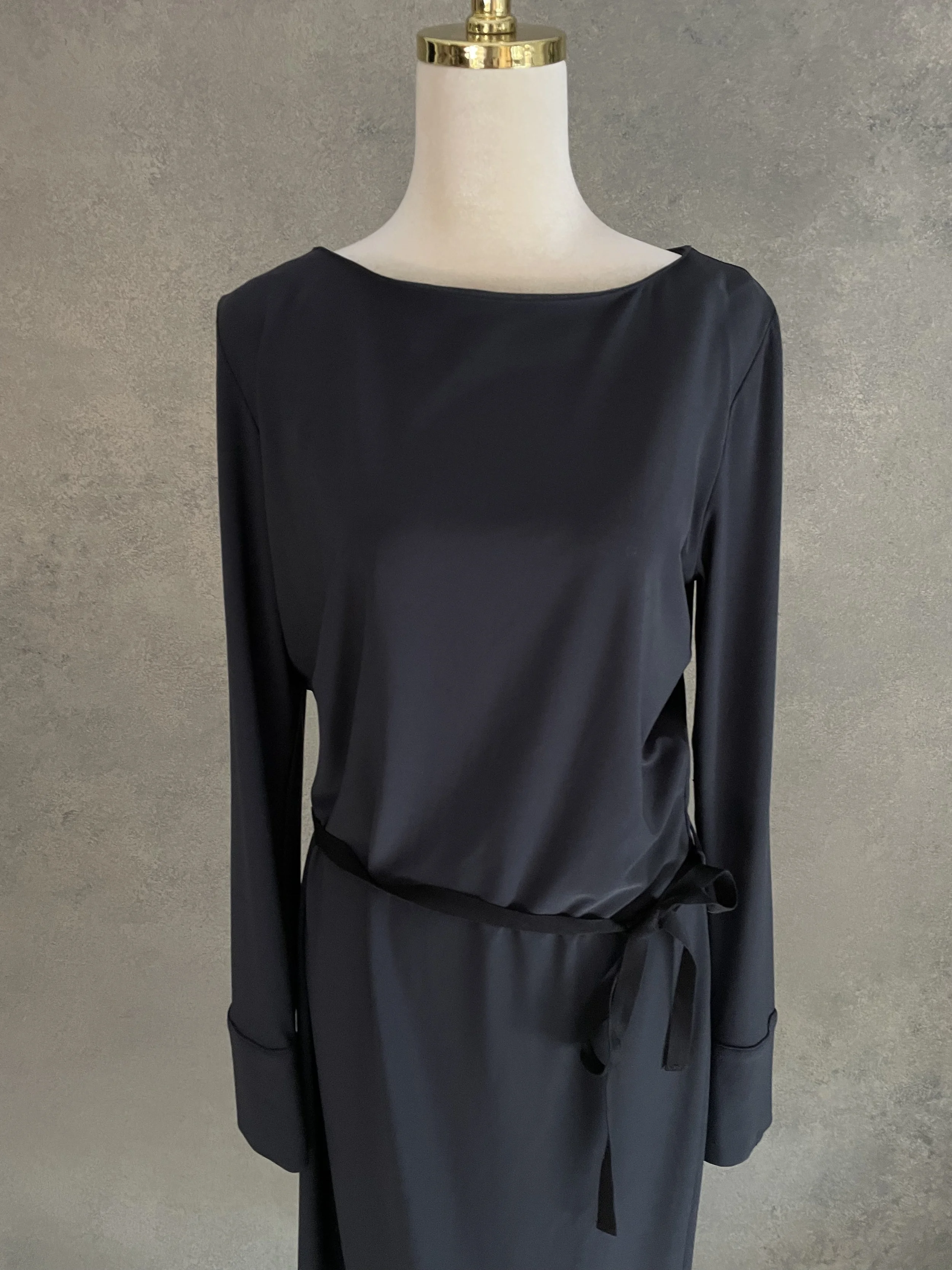 Front-facing shot of the anthracite Rue Blanche dress, showcasing the minimalist neckline and tied waist.