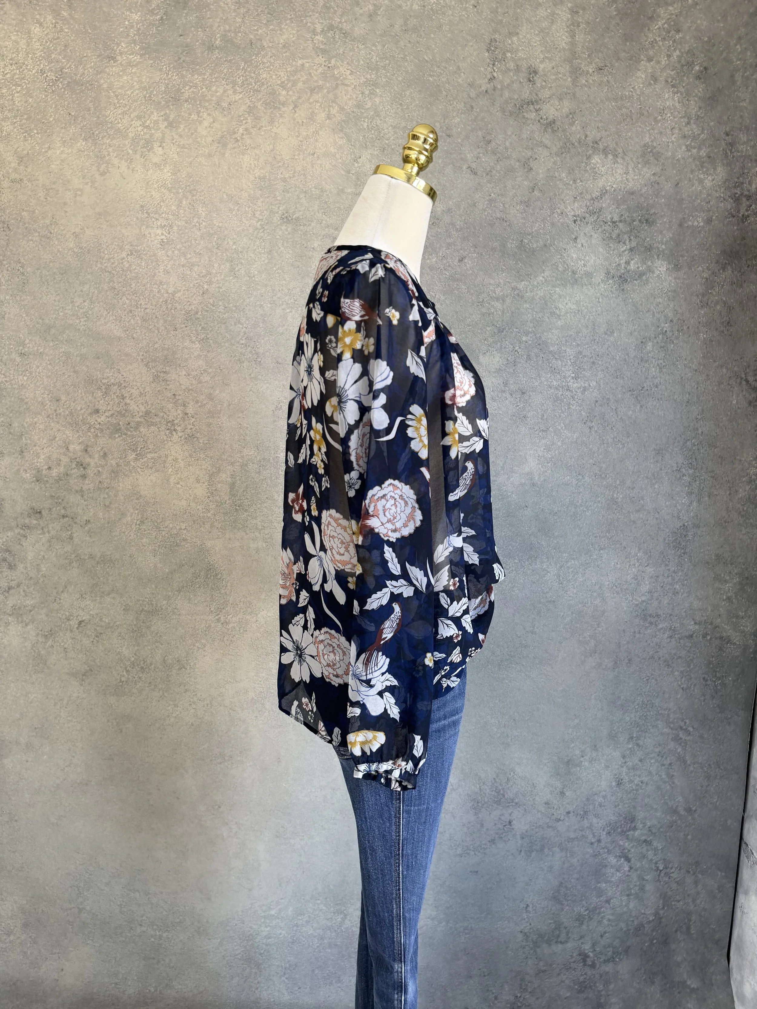 Side profile of the Gigue floral navy blouse, illustrating the relaxed yet refined silhouette