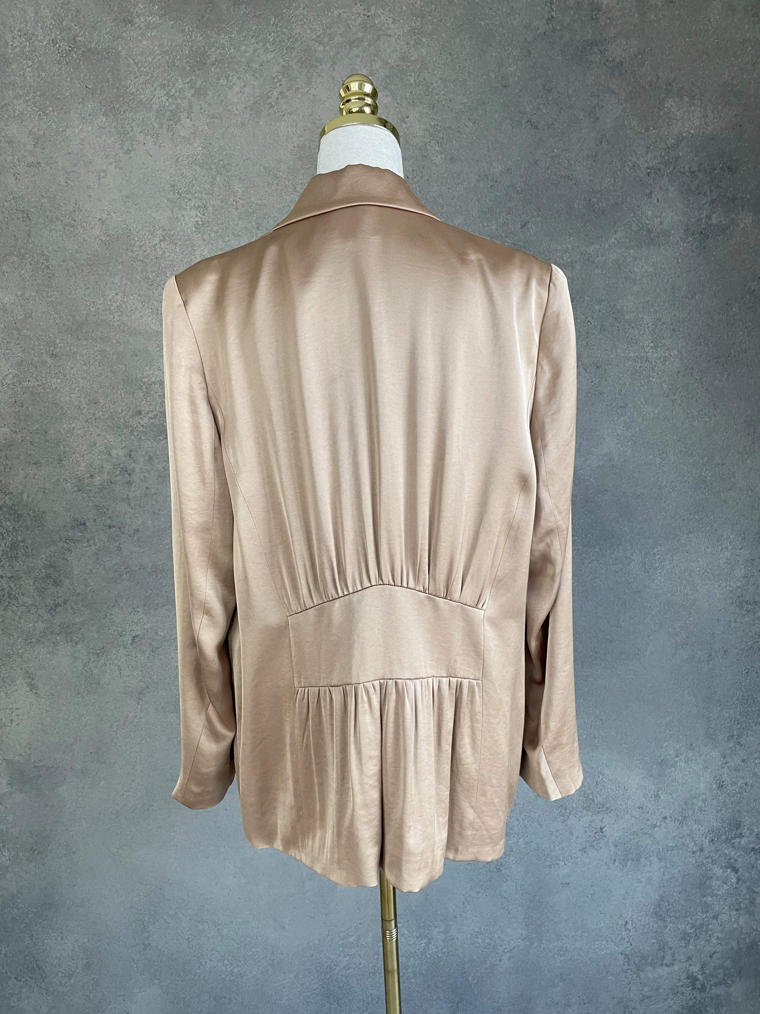Back view of the blazer highlighting the gathered, tailored waist detail.