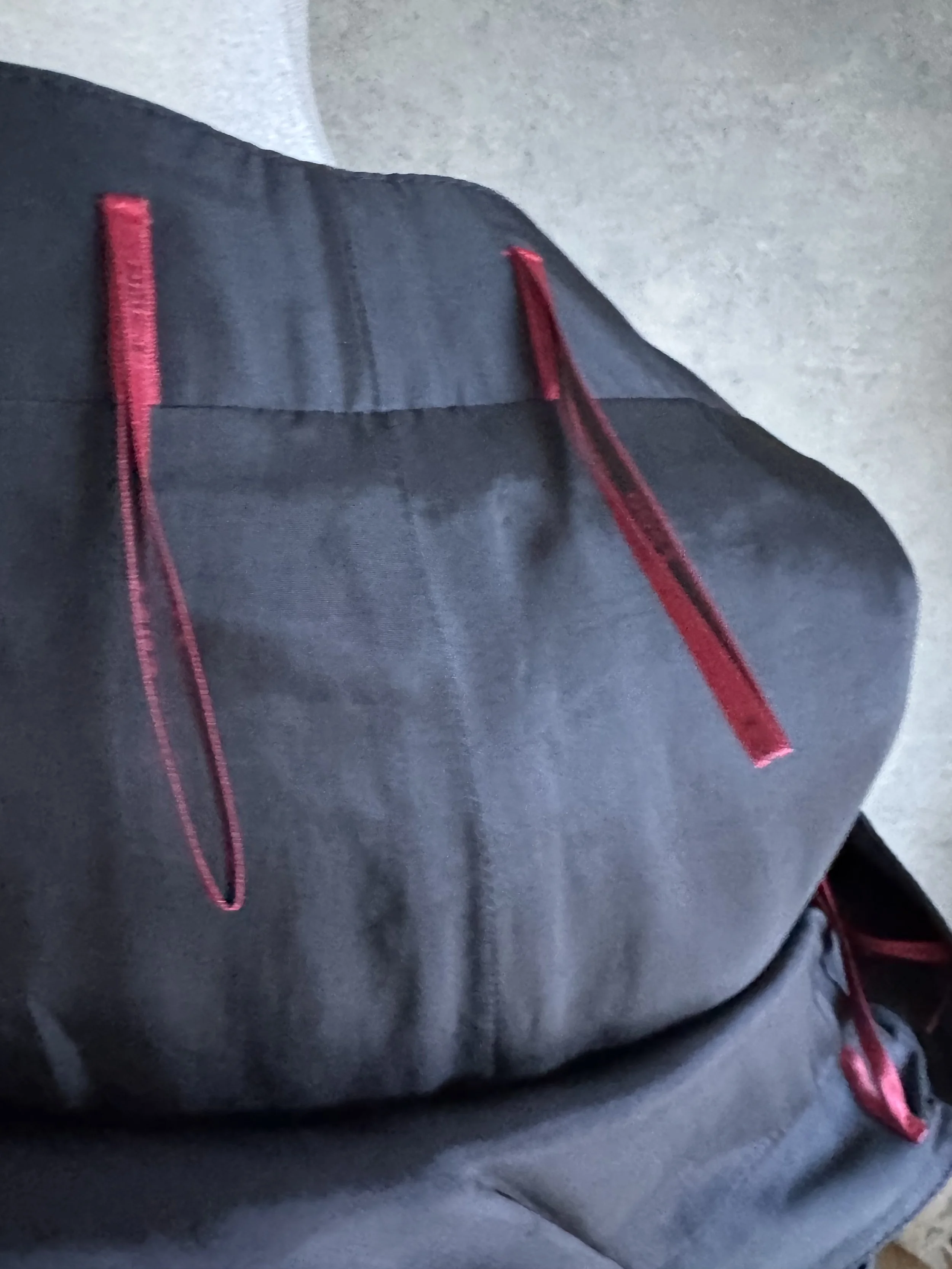 Close-up of the interior red ribbon hanging loops on the HUGO skirt