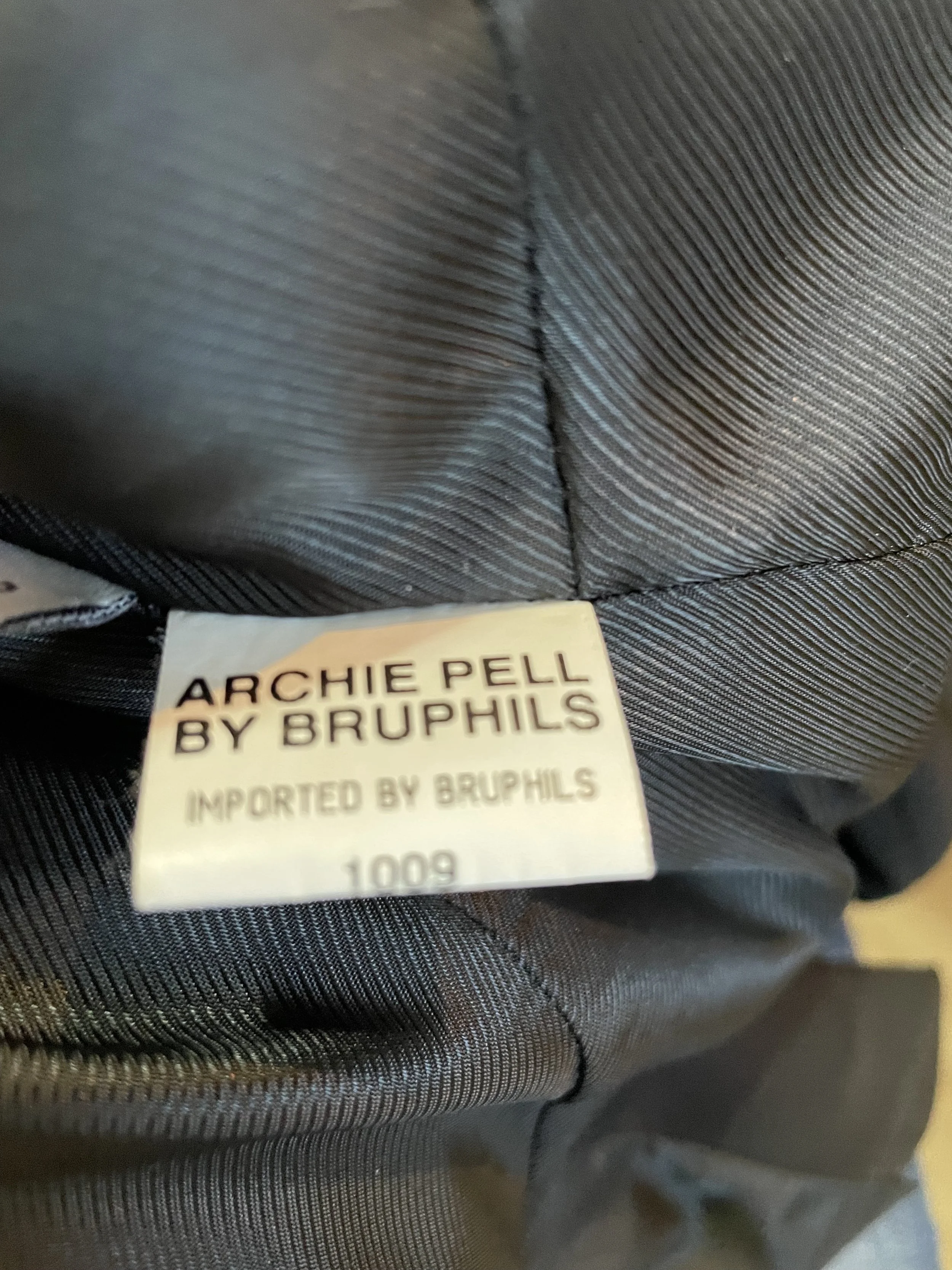Interior tag with "Archie Pell by Bruphils" and import details.