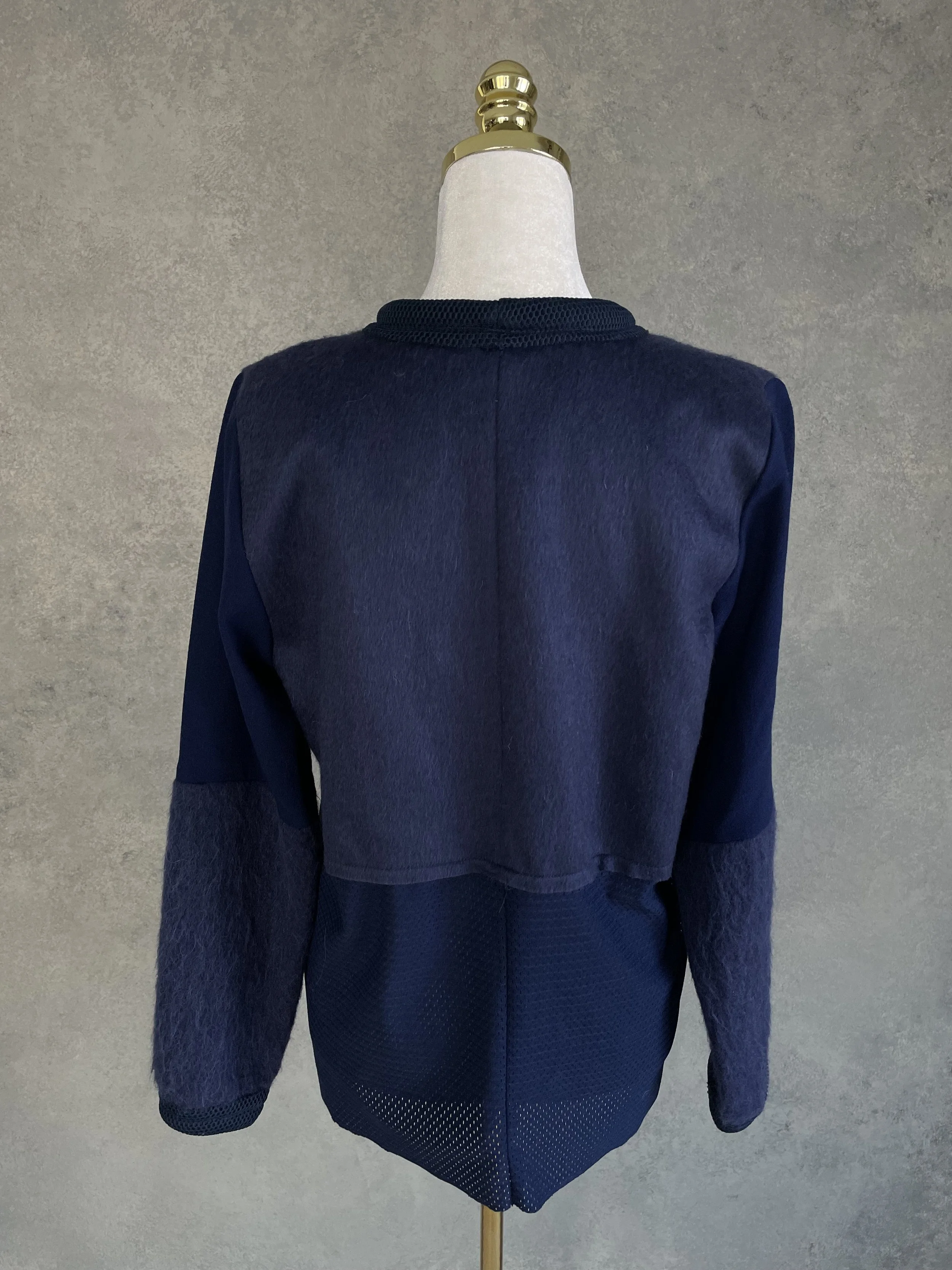 Full back view of the deep navy Vladimir Karaleev sweater, highlighting the clean lines and material paneling.