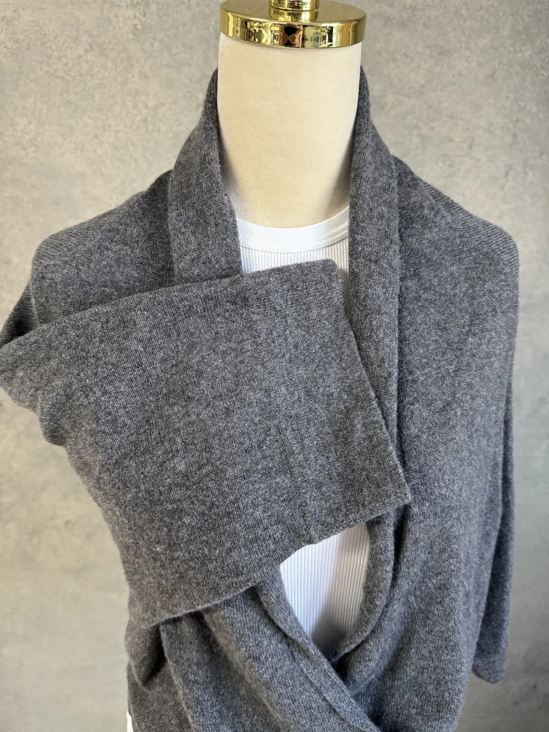 Close-up of wide sleeve and front overlap drape on Hoss Intropia cashmere sweater