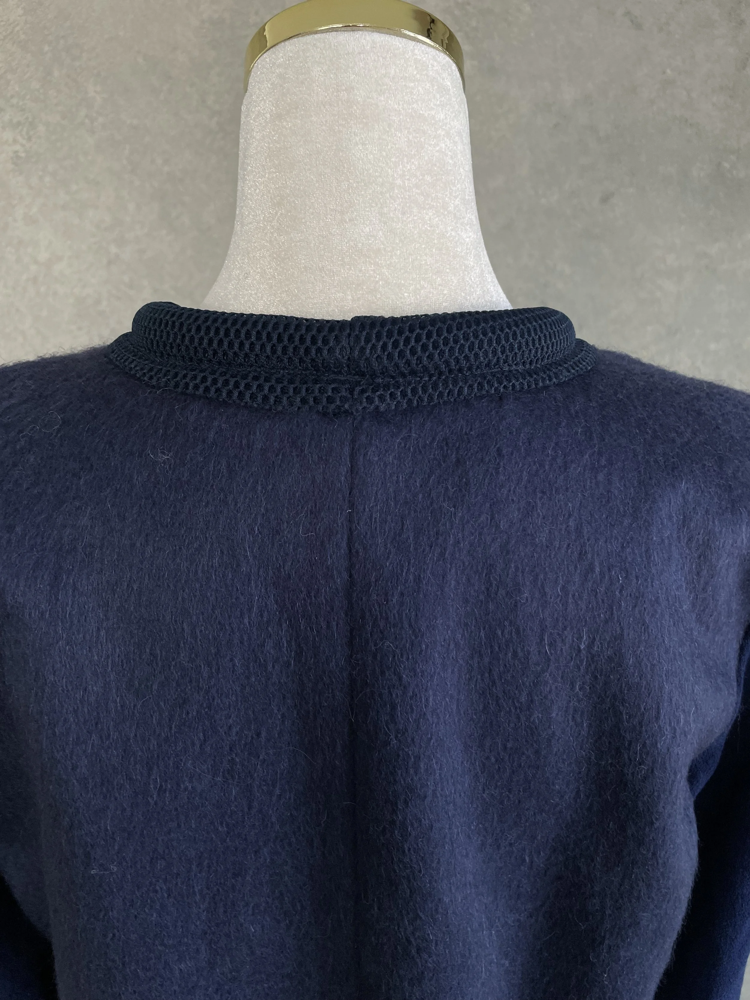 Rear view close-up of the upper back panel and crew neckline construction.