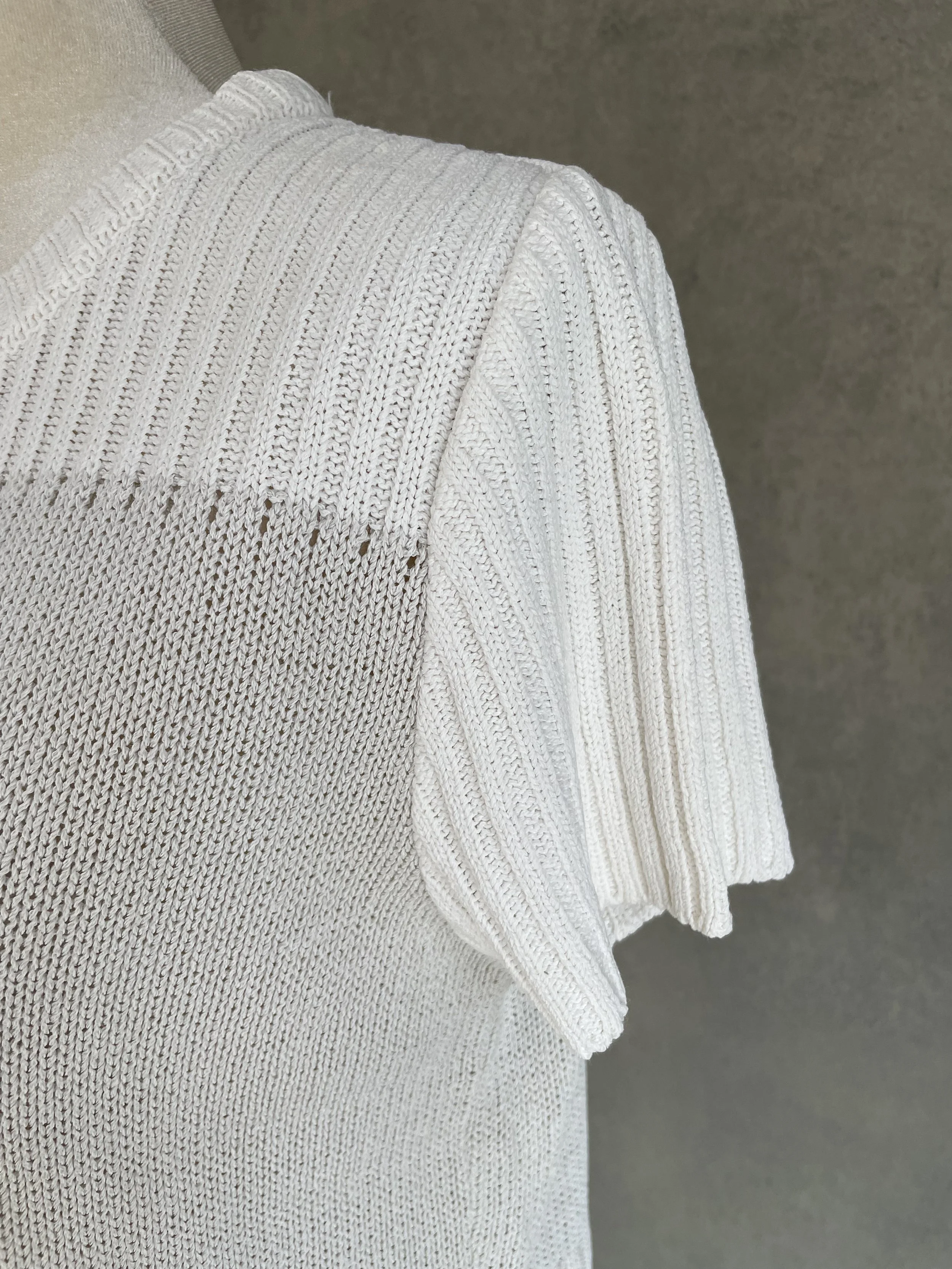 Close-up of the ribbed sleeve and shoulder construction of the Natan beige knit top.