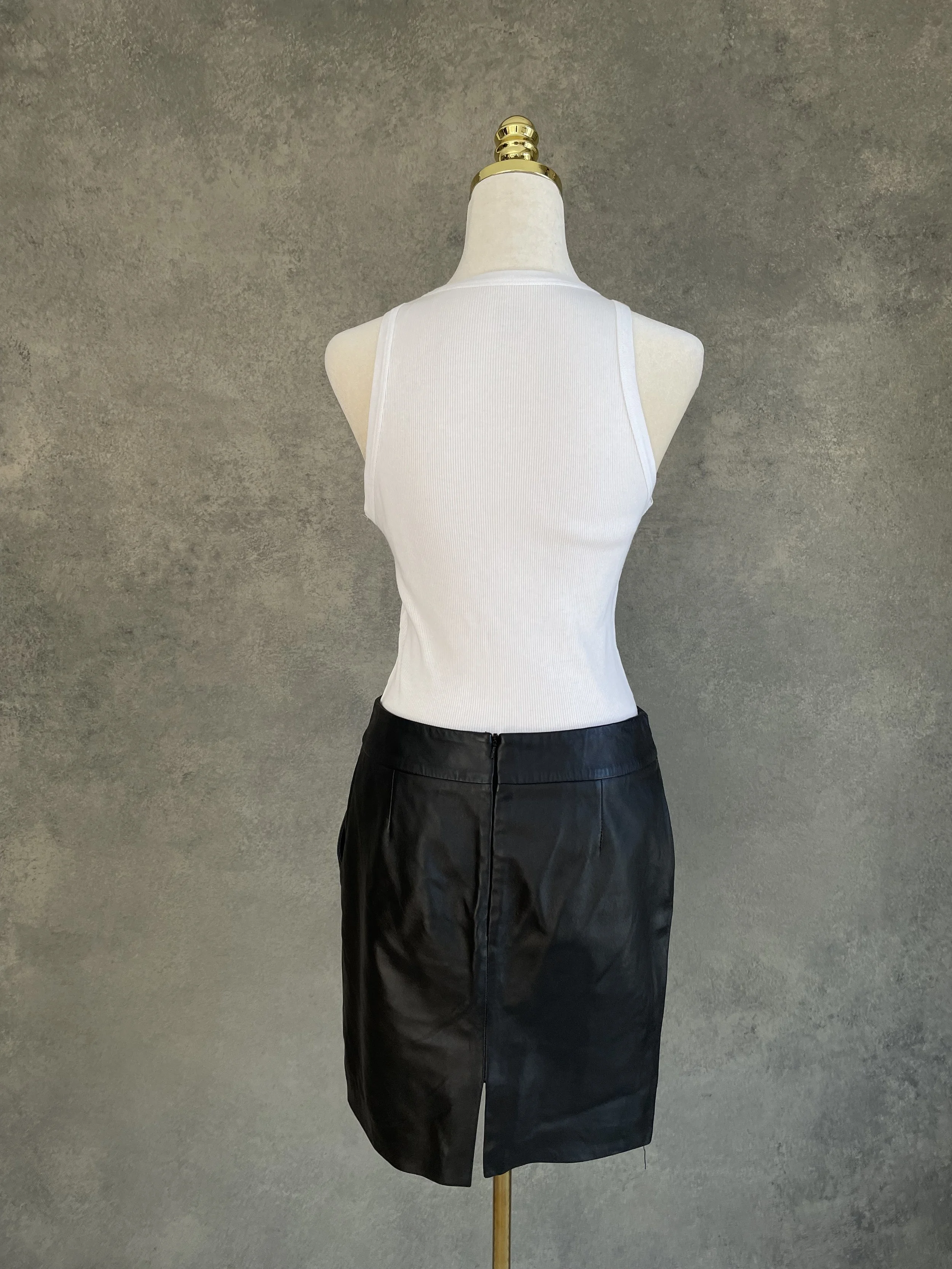 Back view of a black leather pencil skirt by SET with center zipper.