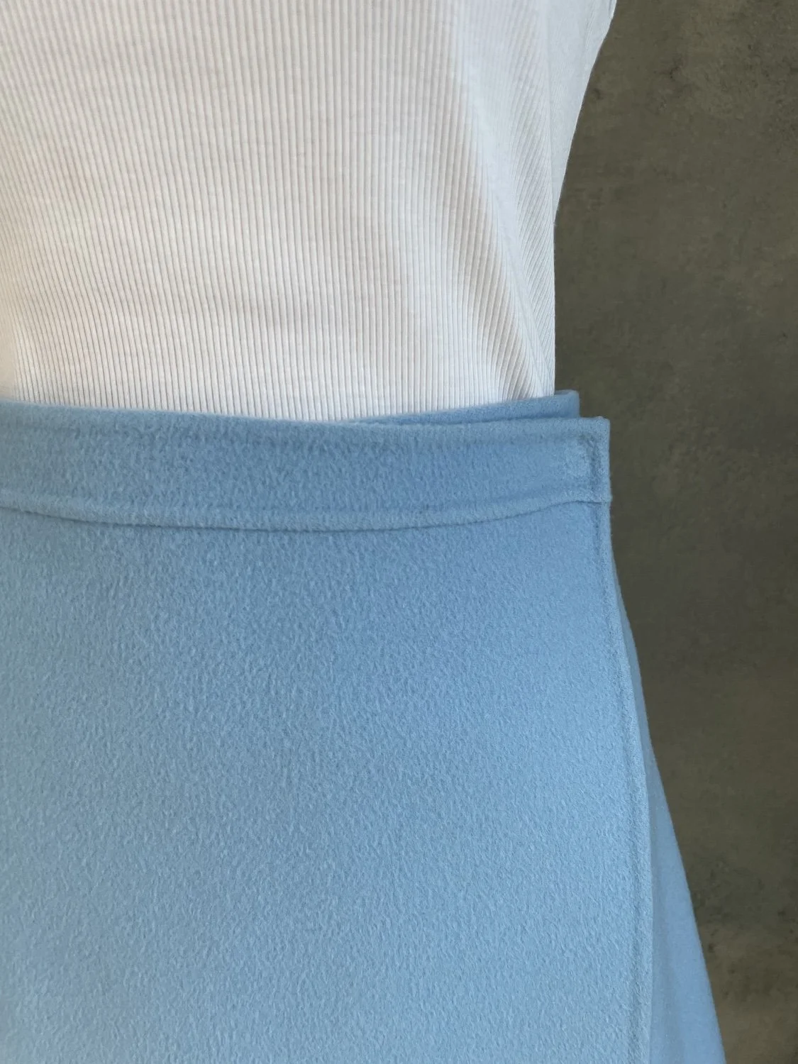 Close-up of the waistband and clean side wrap overlap construction