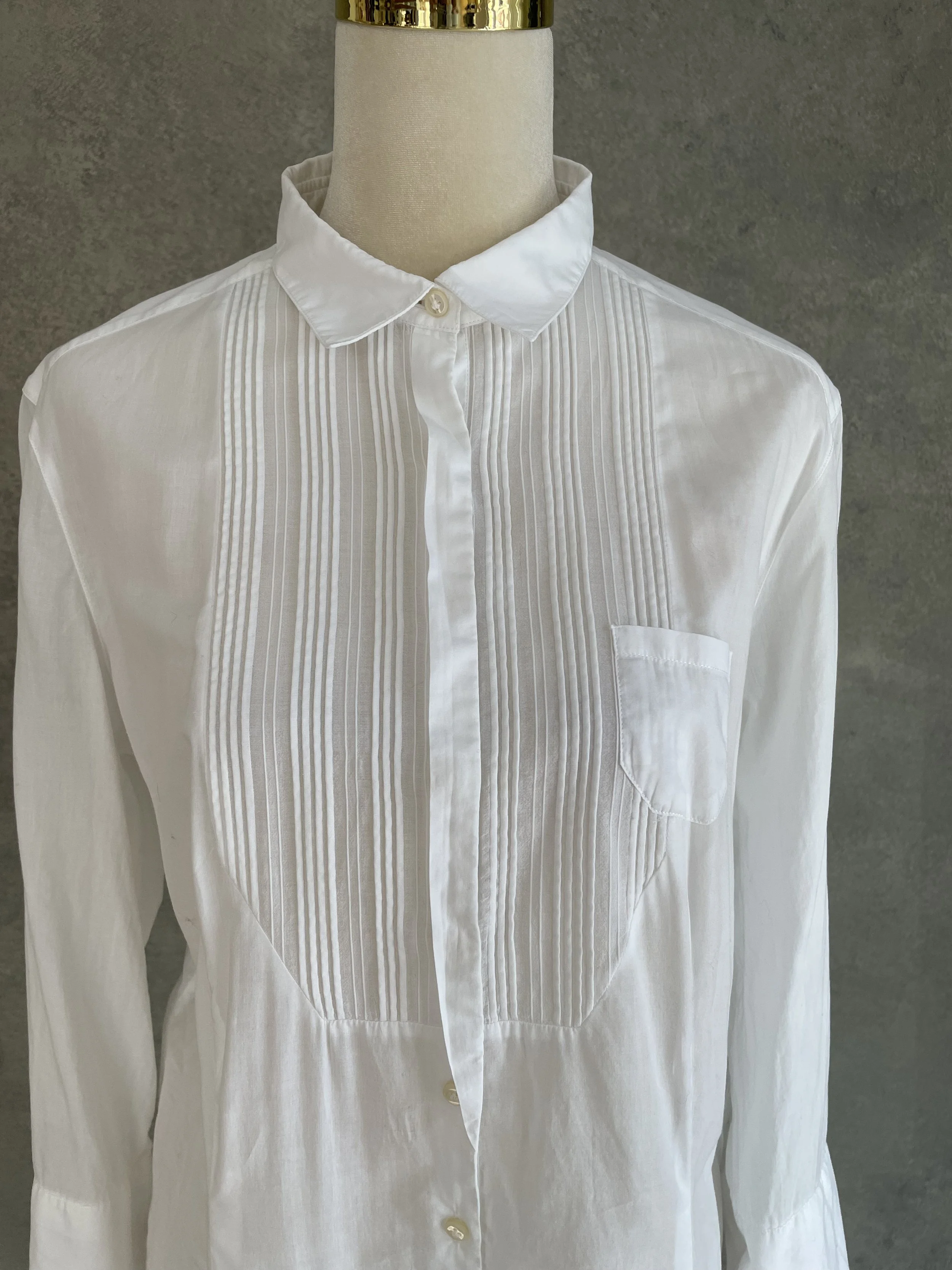 Close-up of the collar and pleated bib front detail.