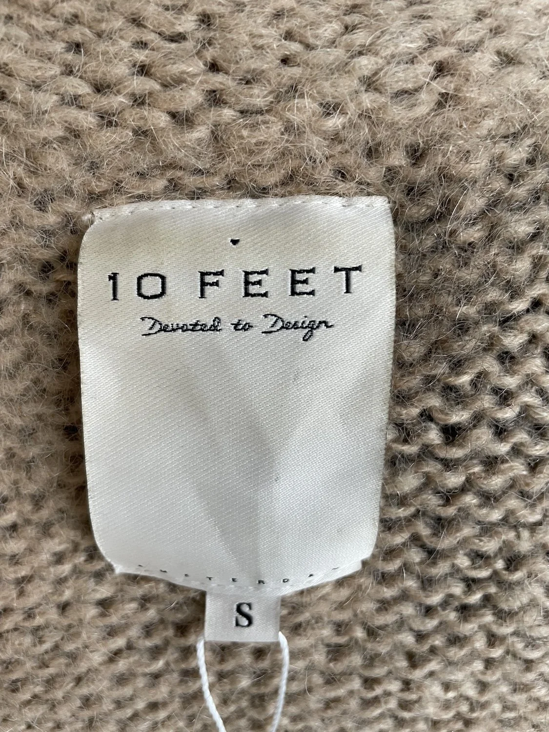 10 Feet brand main label close-up showing size S