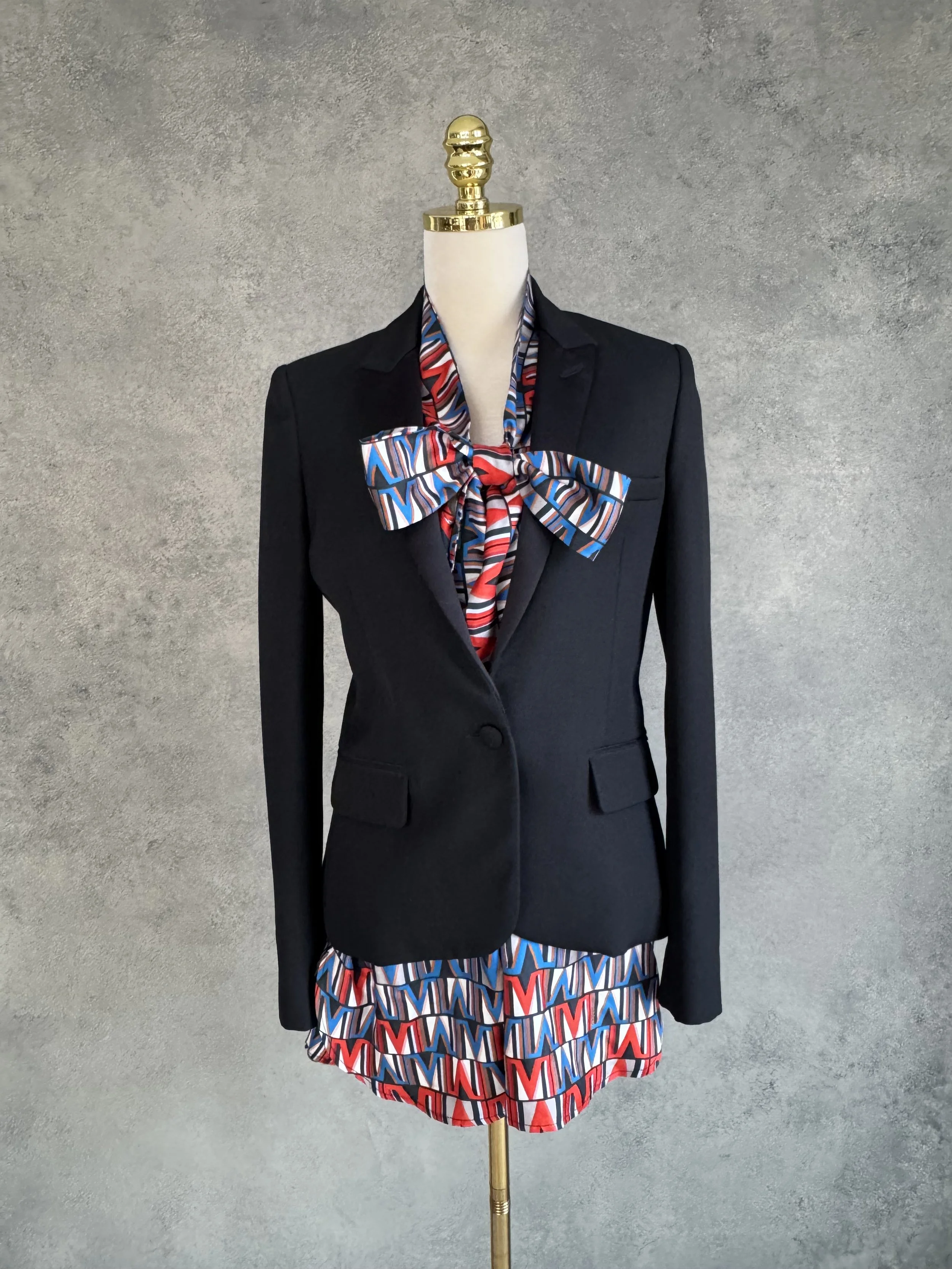 100% silk geometric print blouse layered under a structured black blazer, showcasing professional office styling.