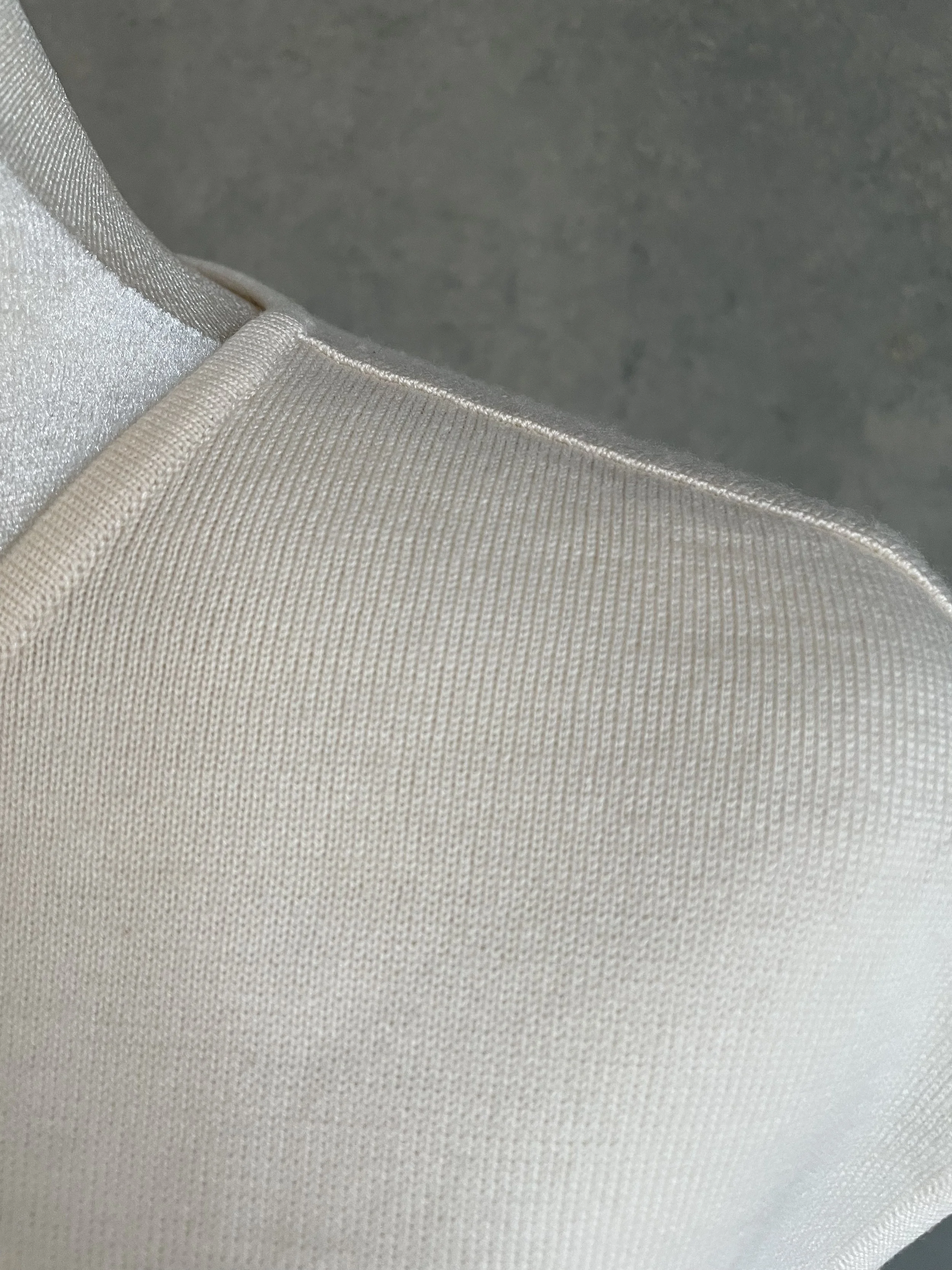 Detail shot of the Escada beige top’s shoulder construction, emphasizing the premium feel and structured knit."