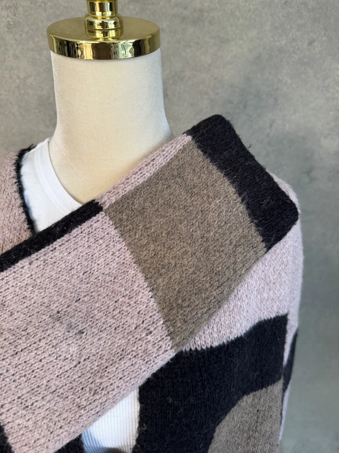 Close-up of sleeve knit pattern and color blocks