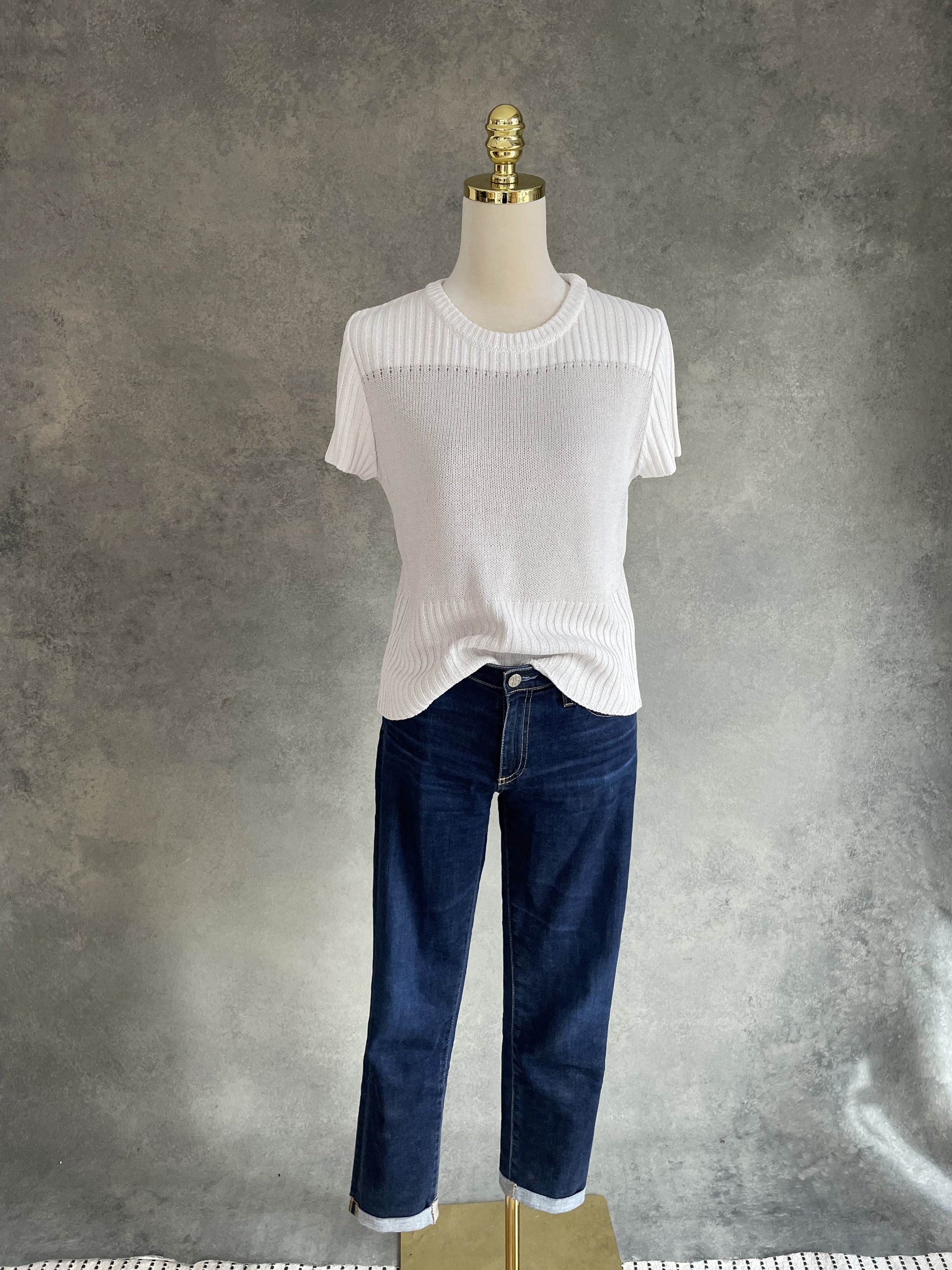 Studio product shot of the Natan beige knit top on a neutral mannequin.
