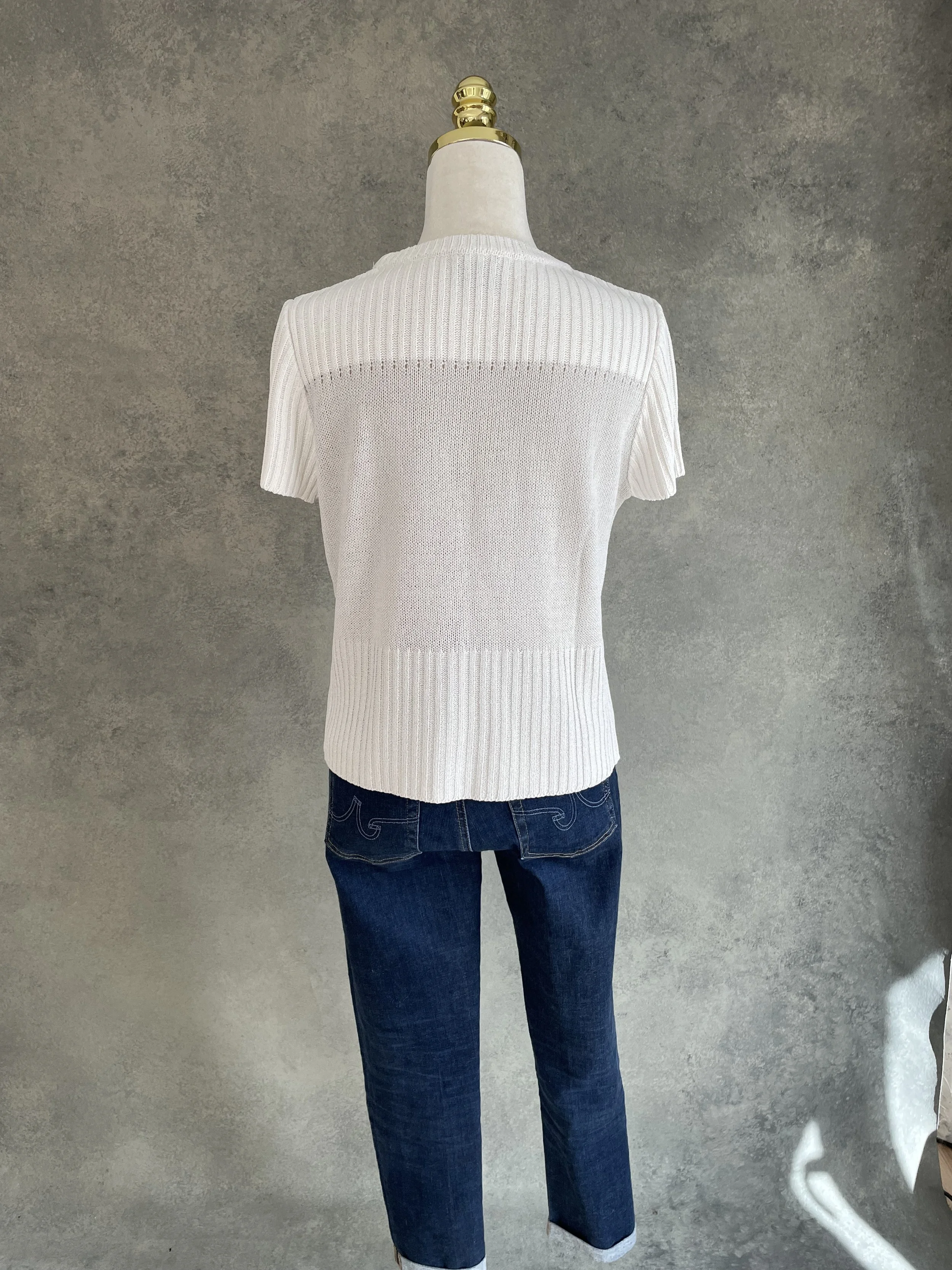 Back view of the Natan beige and silver knit top on a mannequin.