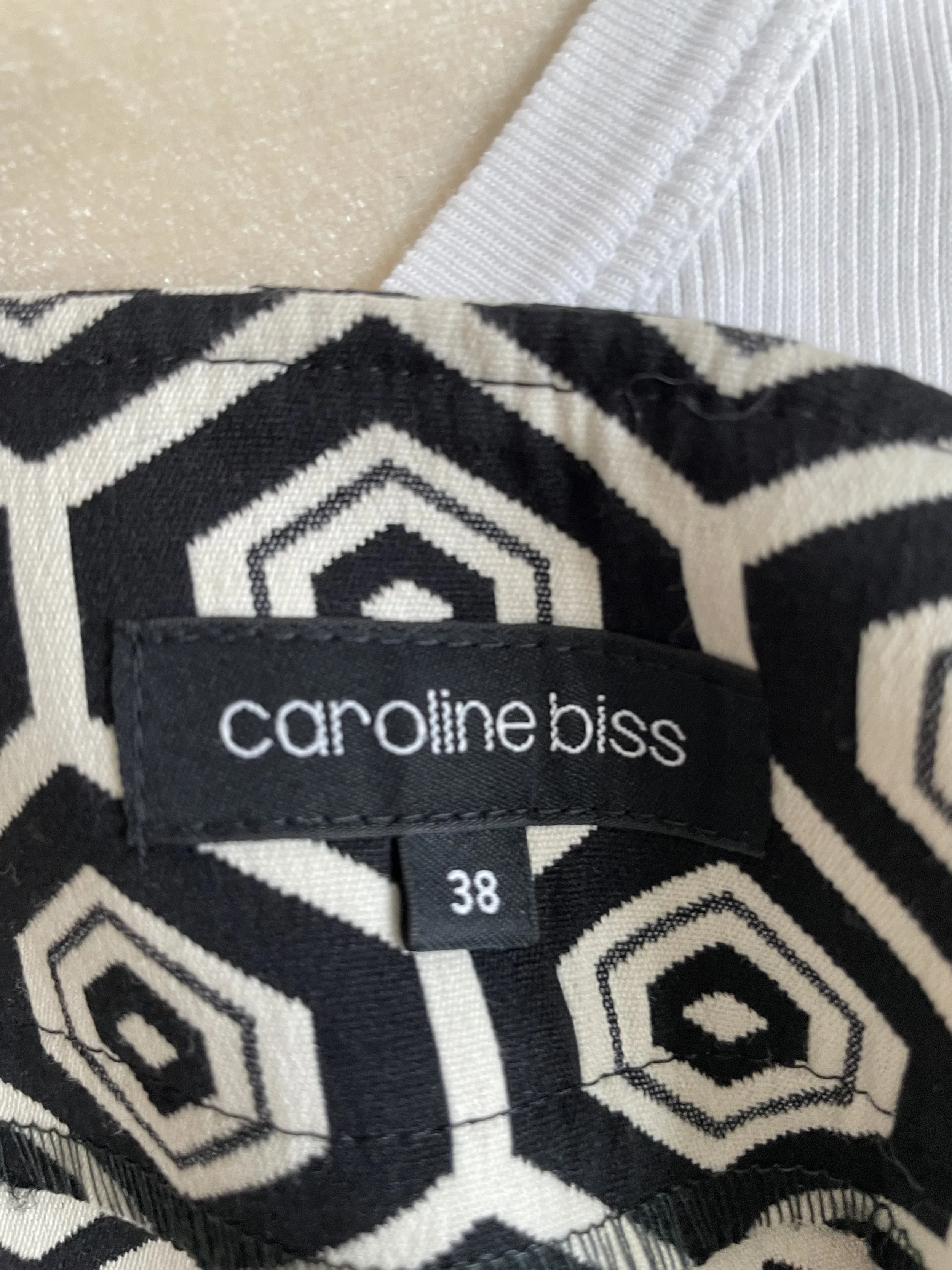 Close-up of Caroline Biss brand tag and size 38 label.