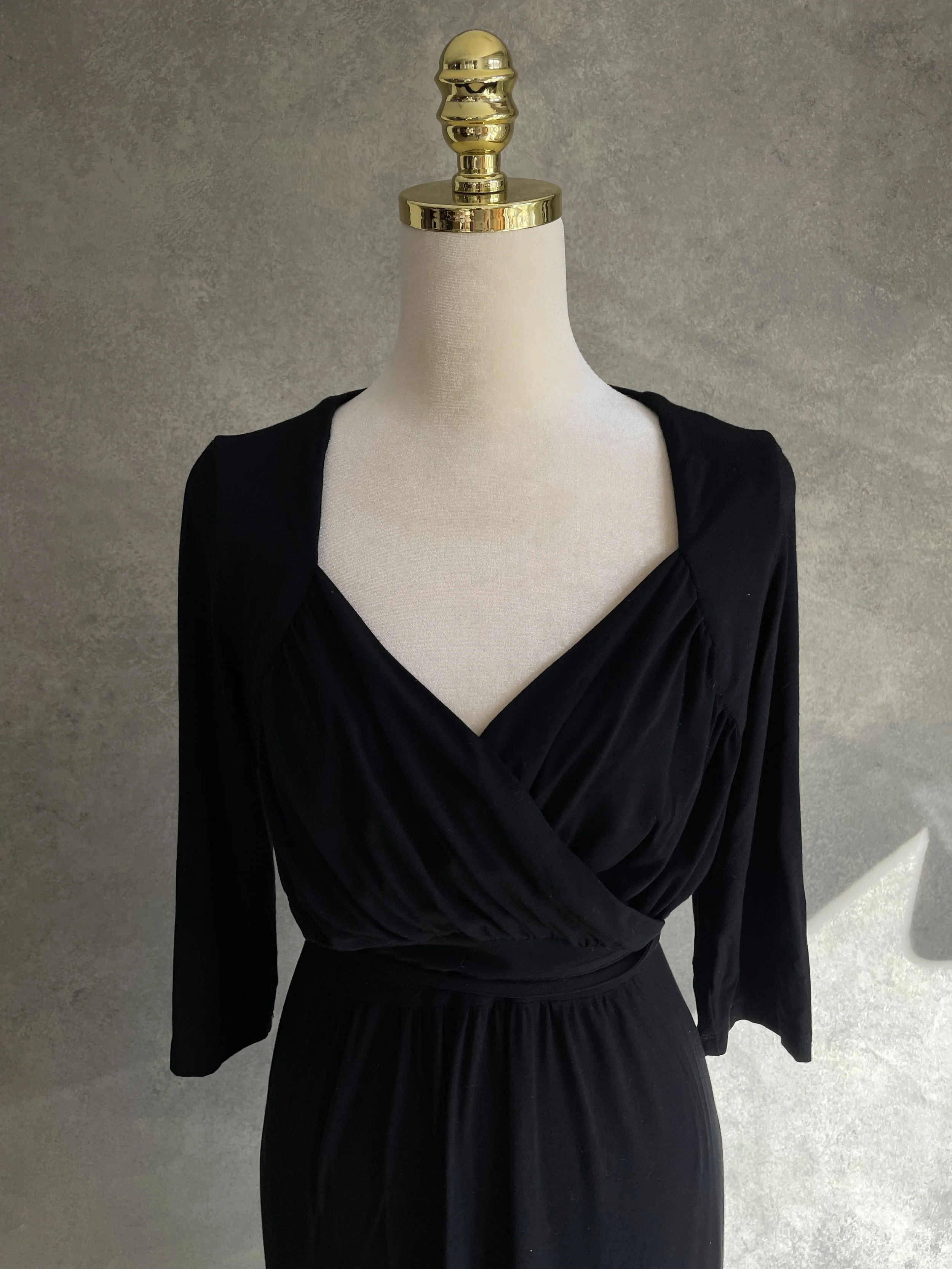 Close-up front view of the Scapa jersey wrap dress showcasing the draped bodice and wrap-front detail.
