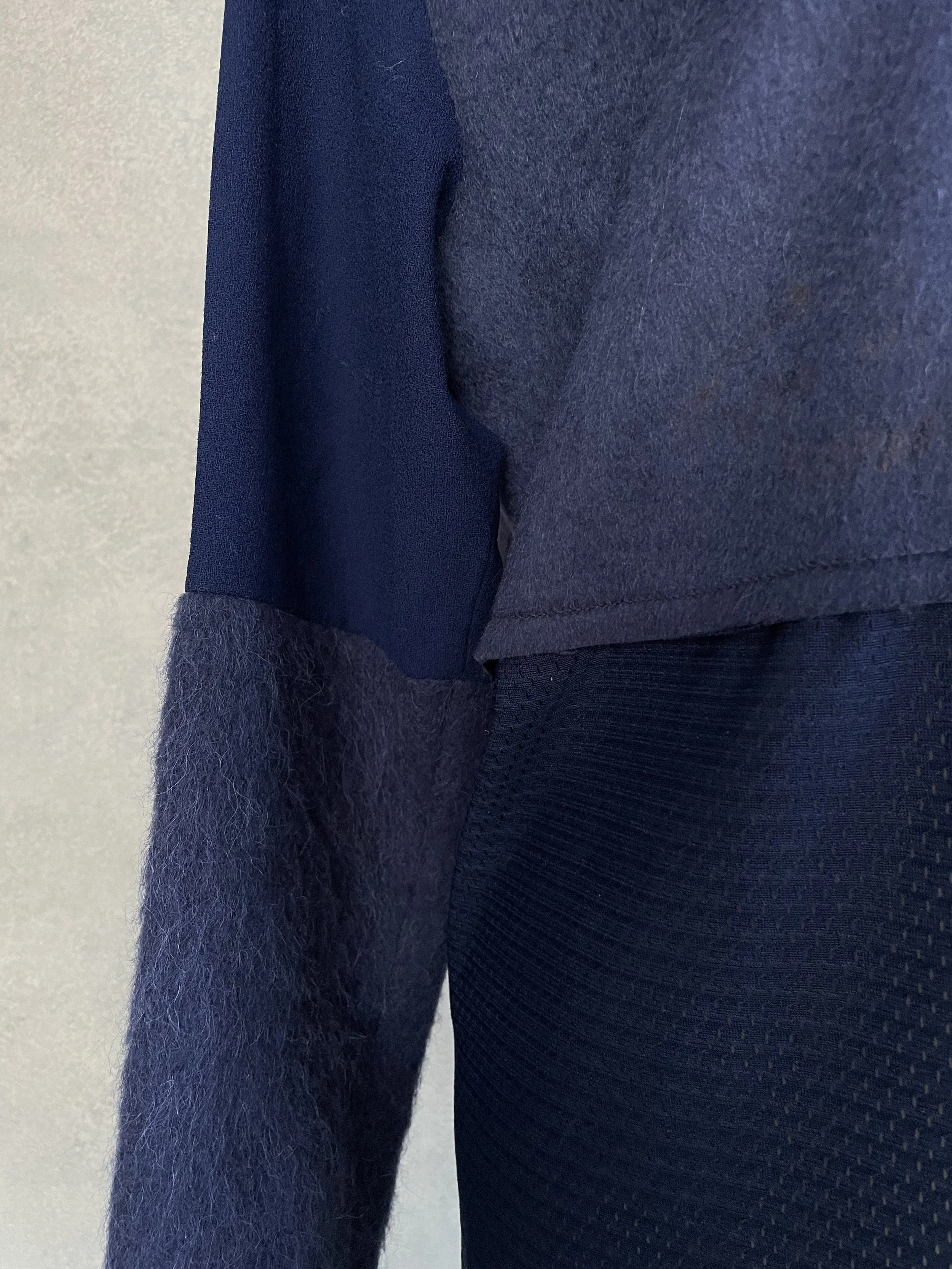 Detail shot of the seam construction on the sleeve, showing the transition between different fabric textures.
