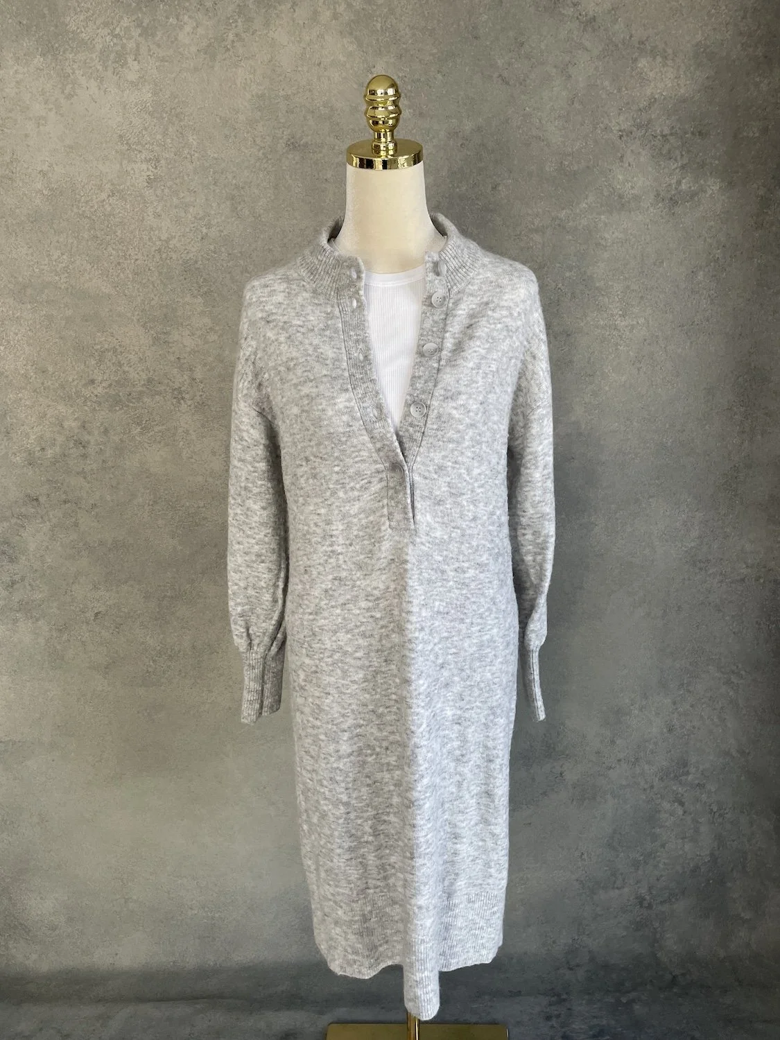 Xandres light grey knit midi dress styled with white long-sleeve base layer front view on mannequin