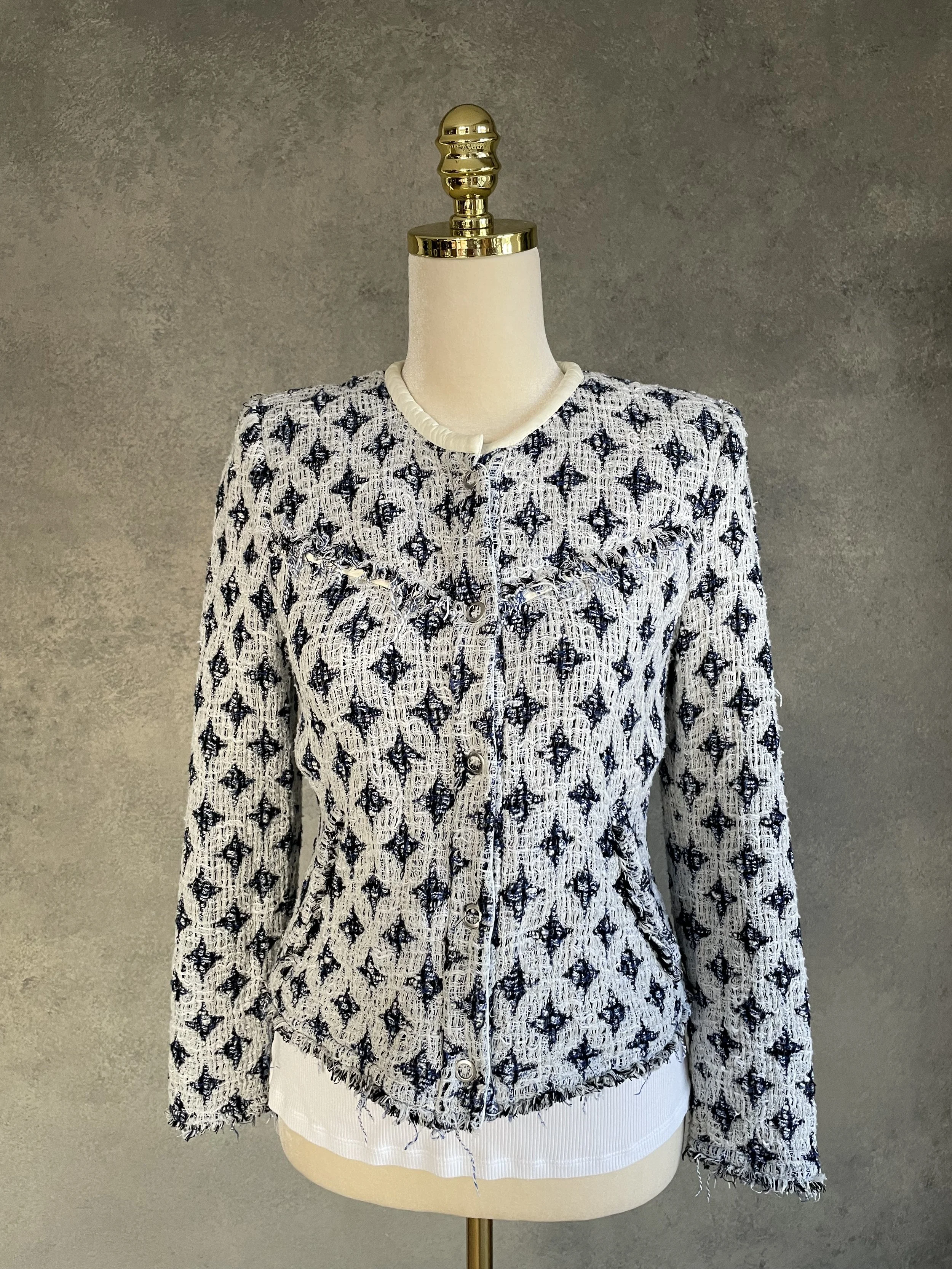Full front view of the IRO tweed jacket buttoned up on a mannequin, highlighting the cropped, structured fit.