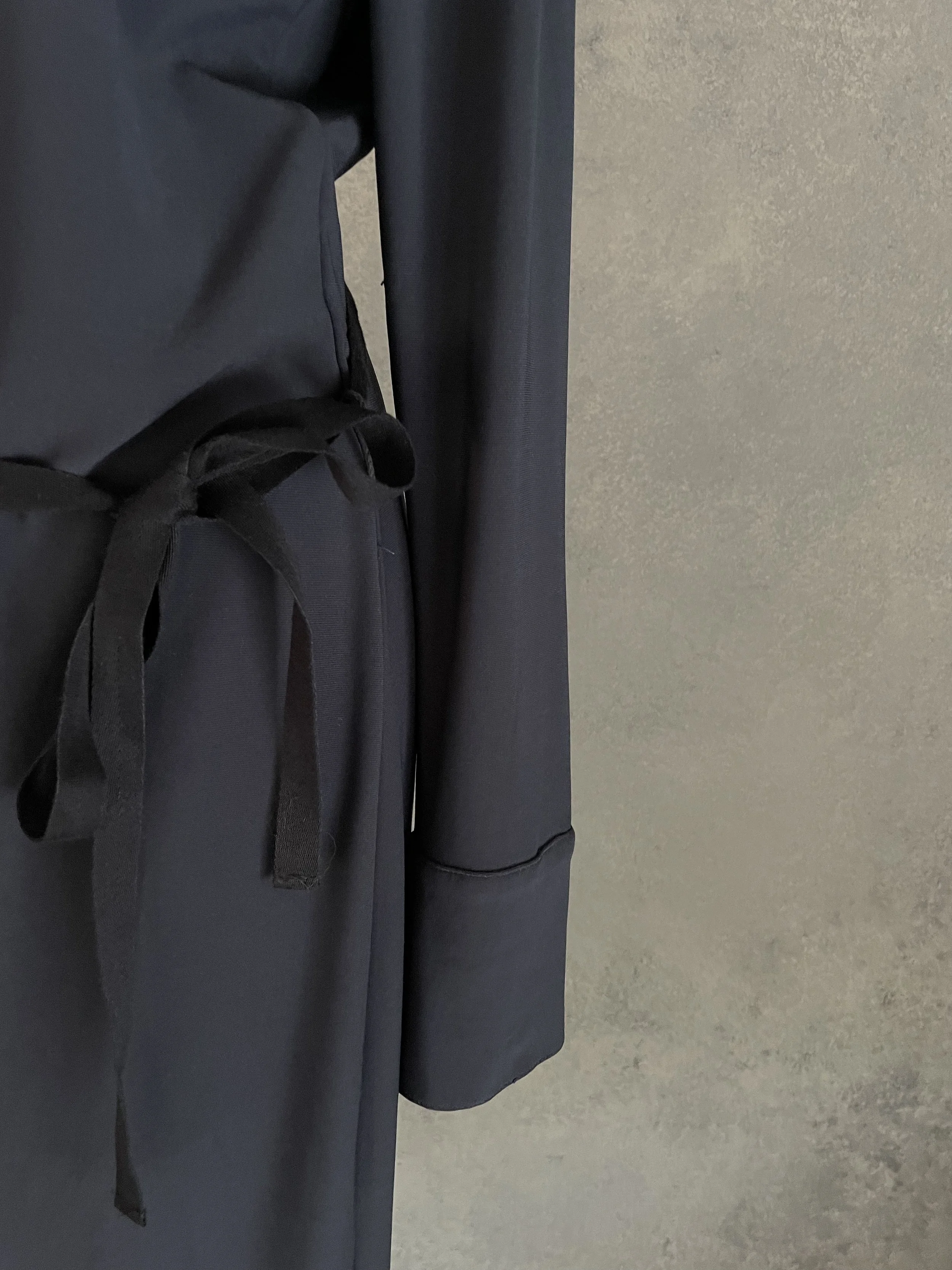 Detail shot highlighting the waist belt and sleeve tailoring of the anthracite midi dress.