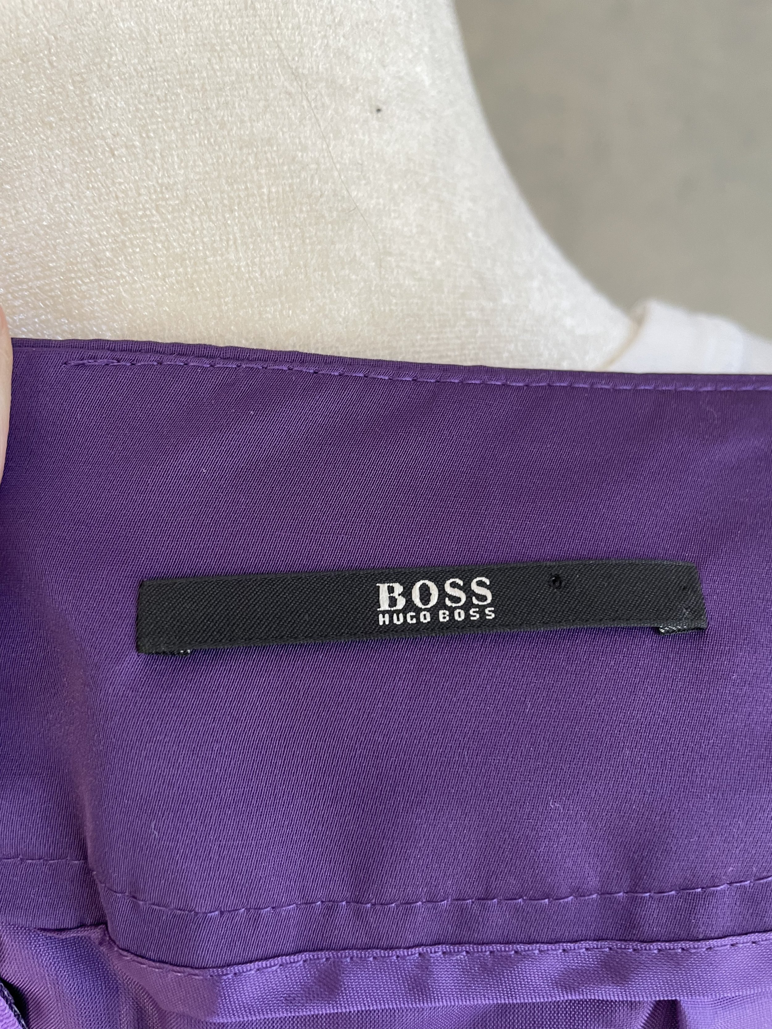 Close-up of the BOSS HUGO BOSS brand label on the interior of the purple skirt.