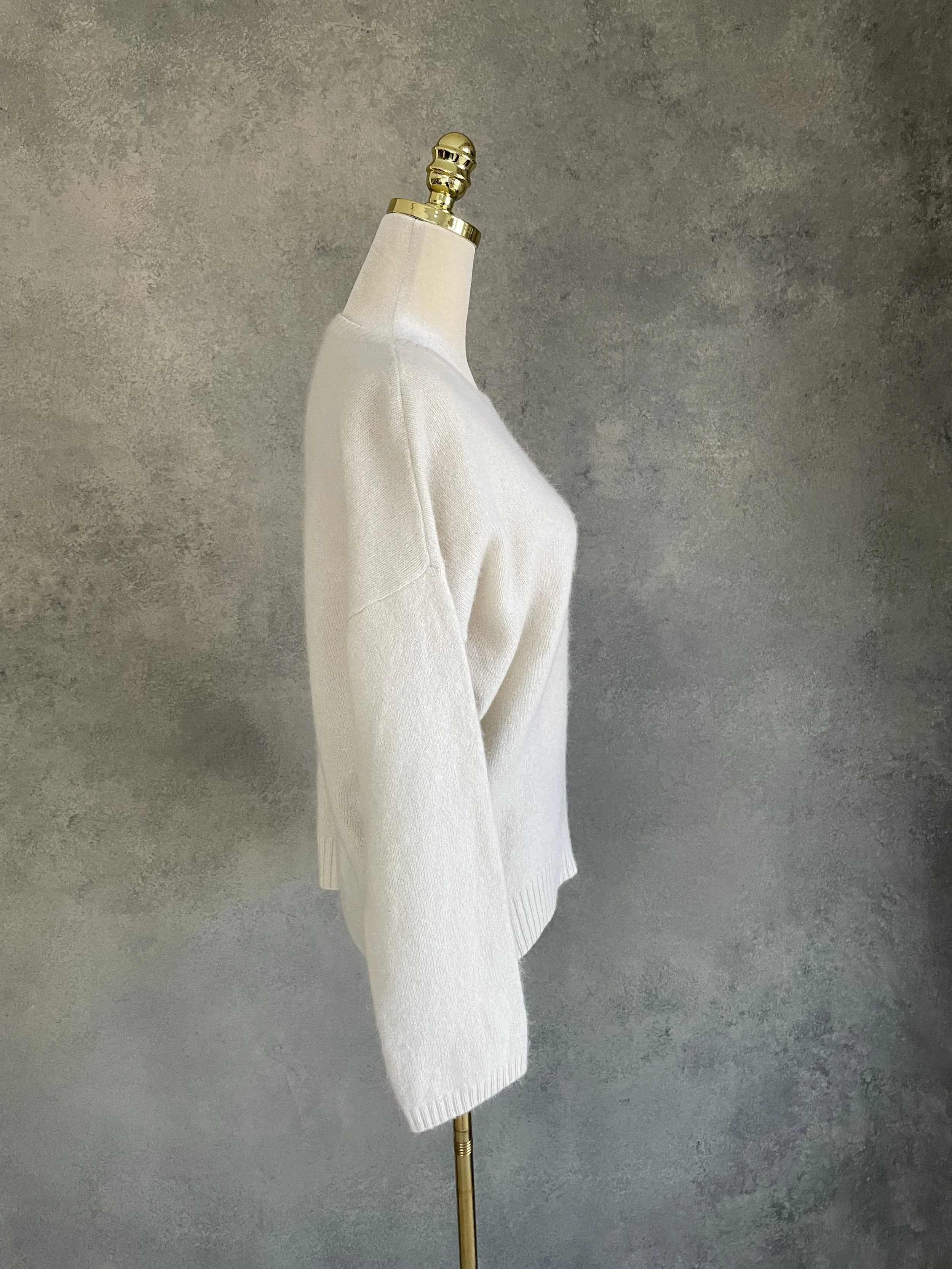 Side profile view of a Rue Blanche cream angora-blend sweater, showcasing the relaxed fit.