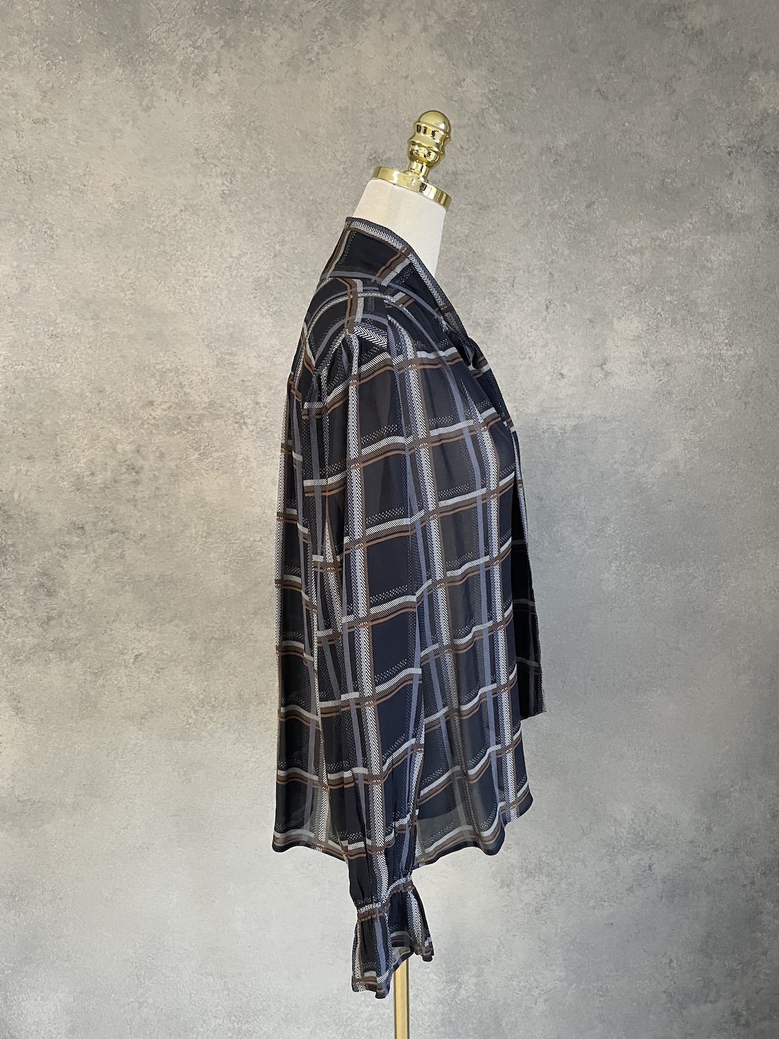 Side profile view of the Caroline Biss blouse (image_0.png) on the mannequin. Shows the length and the relaxed, boxy fit, as well as the back yoke detail.
