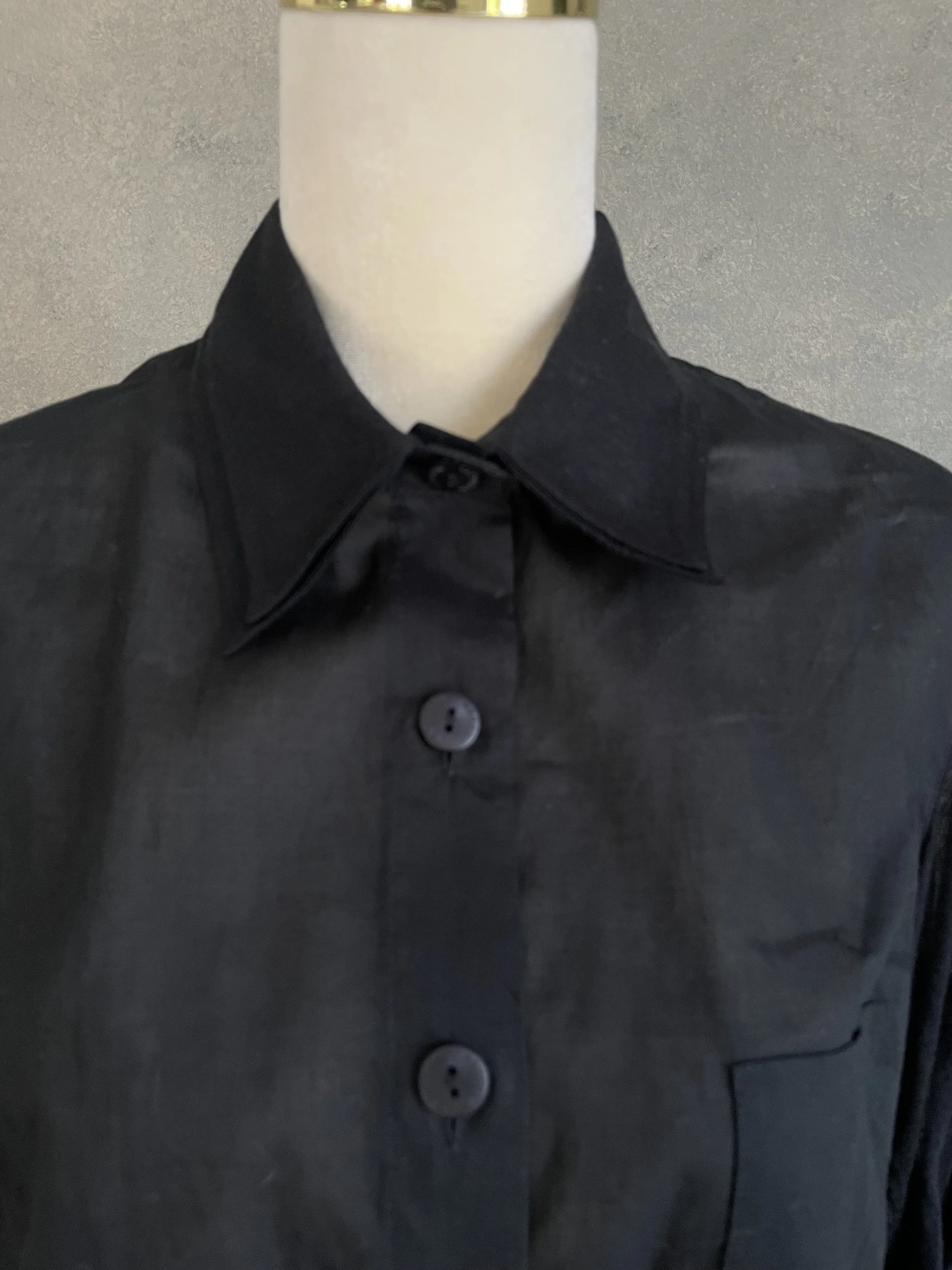 Close-up detail of the Kathleen Madden blouse neckline, showing the clean finish and high-quality tailoring