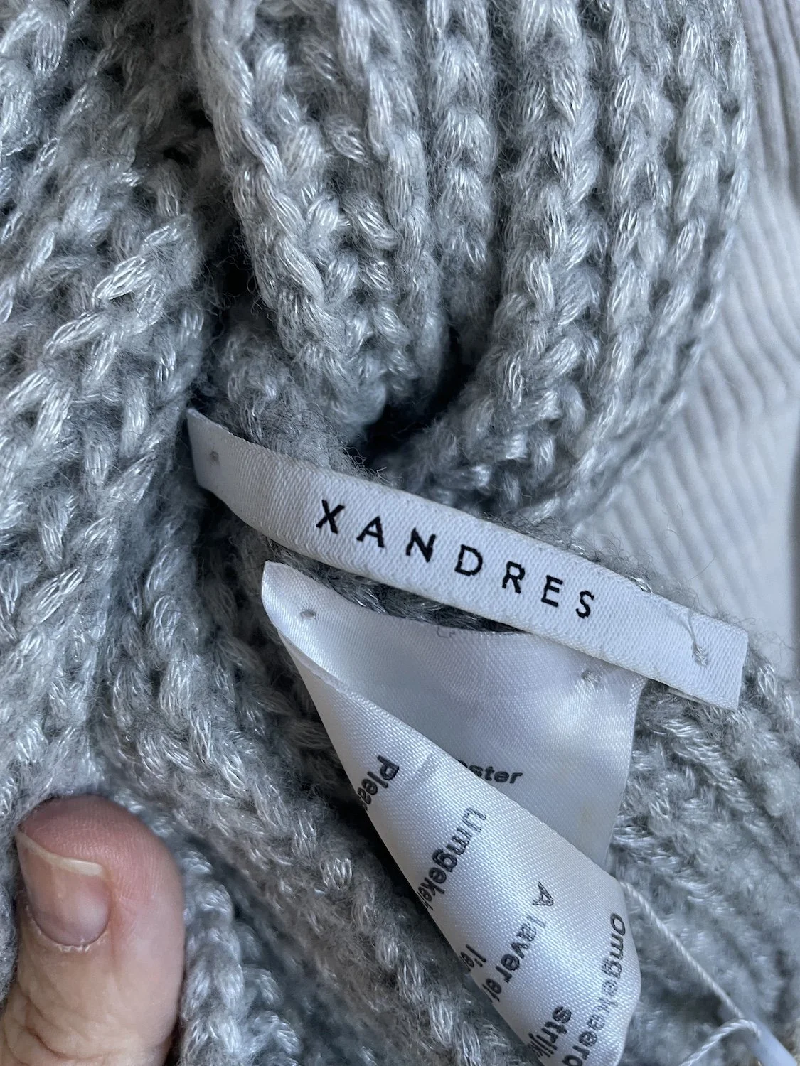 Close-up of the interior Xandres brand label and care tag.