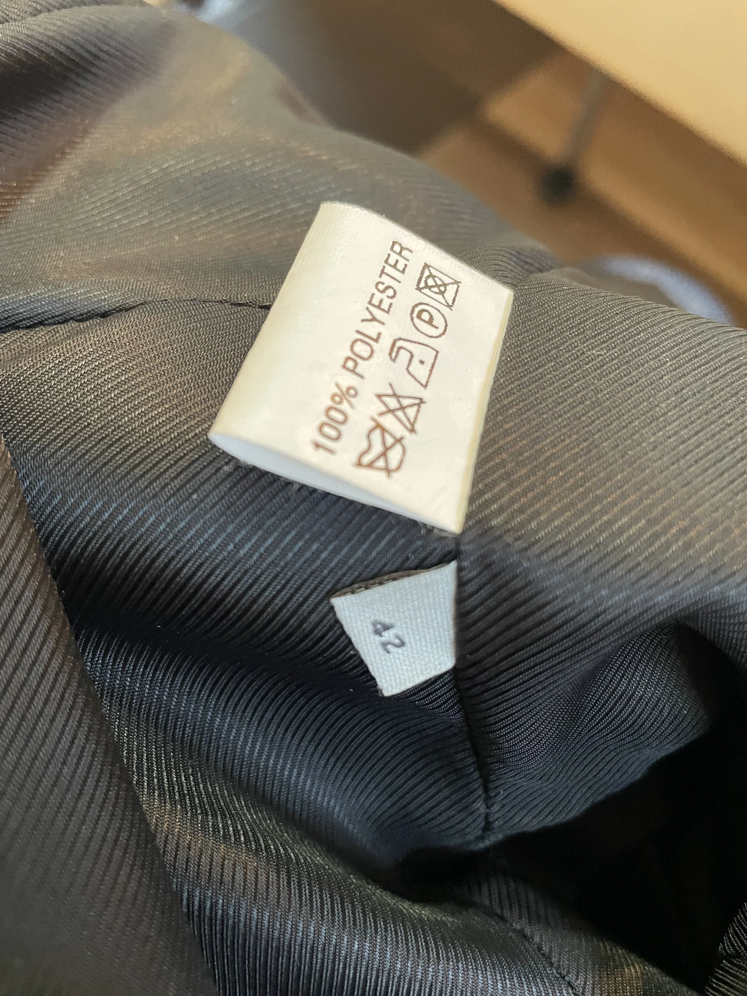 Care label detailing "100% Polyester" and size "42".