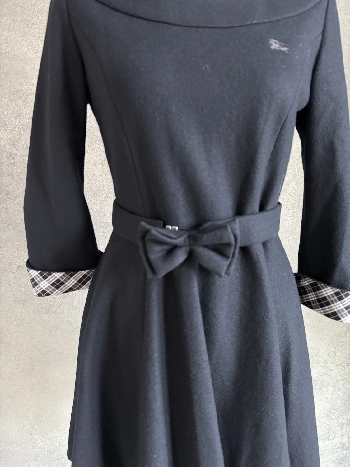 Close-up of the waist belt with a bow detail on the Burberry dress