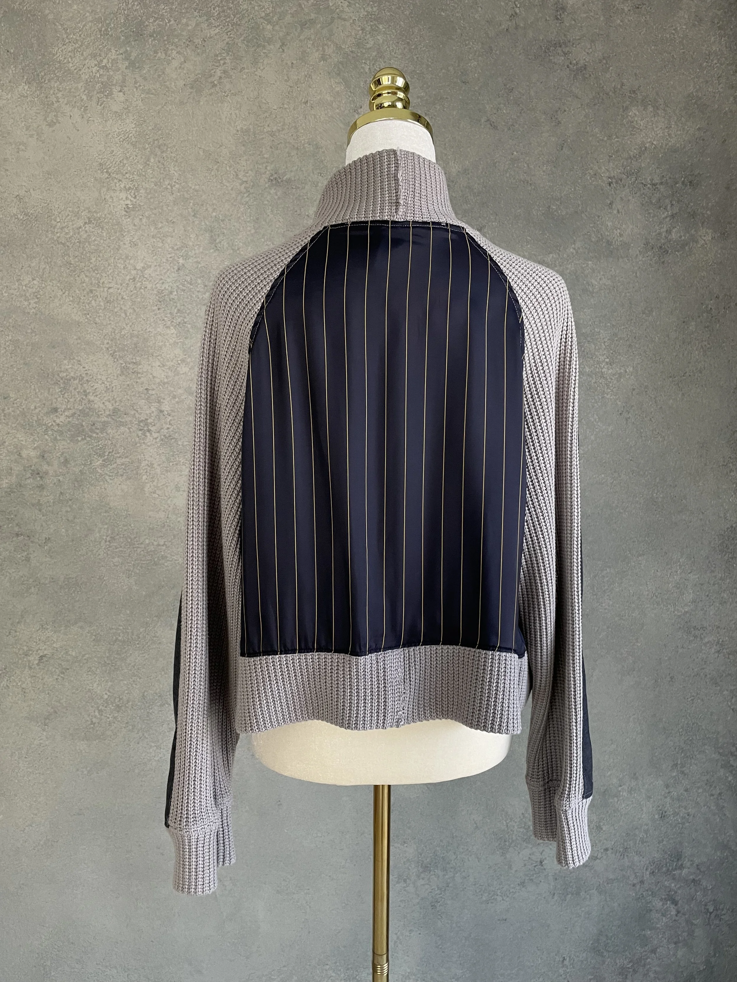 Full back view of the Vladimir Karaleev pinstripe and knit panel sweater.