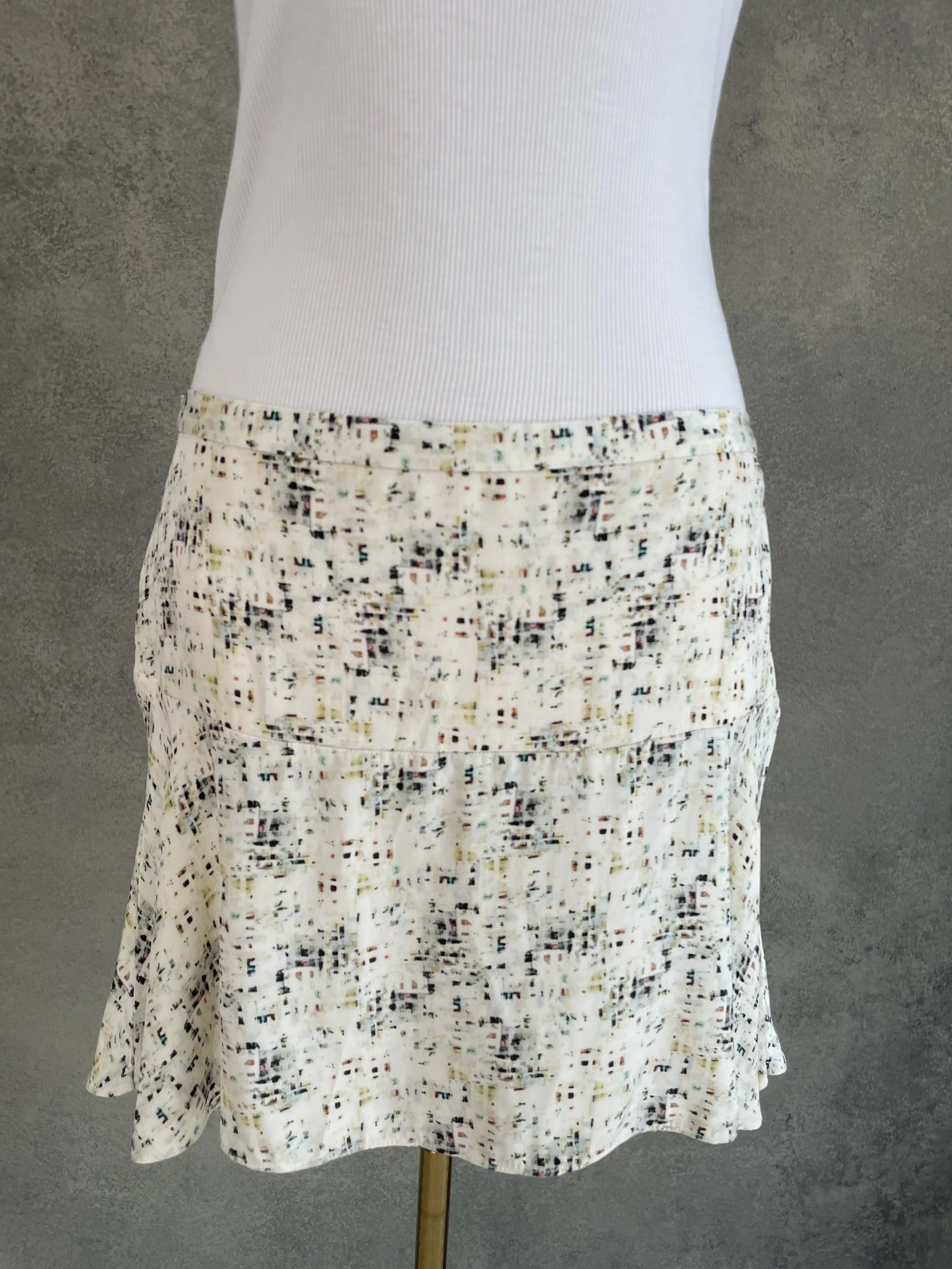 Close-up of the front fabric and layered hem detail of a Joseph mini skirt.